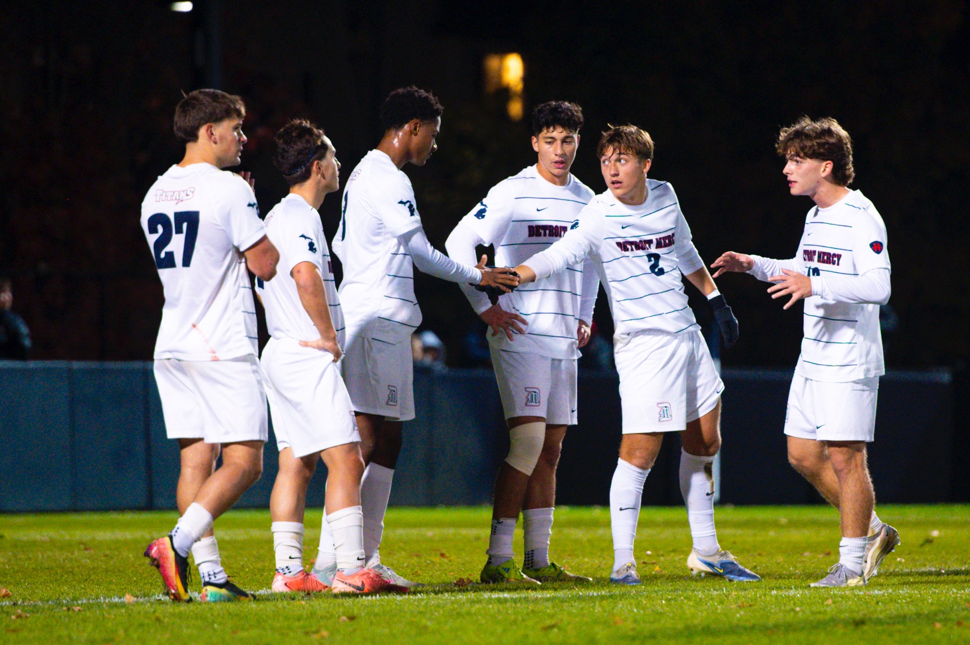 Vincent Stockton, senior midfielder/defense (2), high-fives Tom Nkassa, freshman defense.