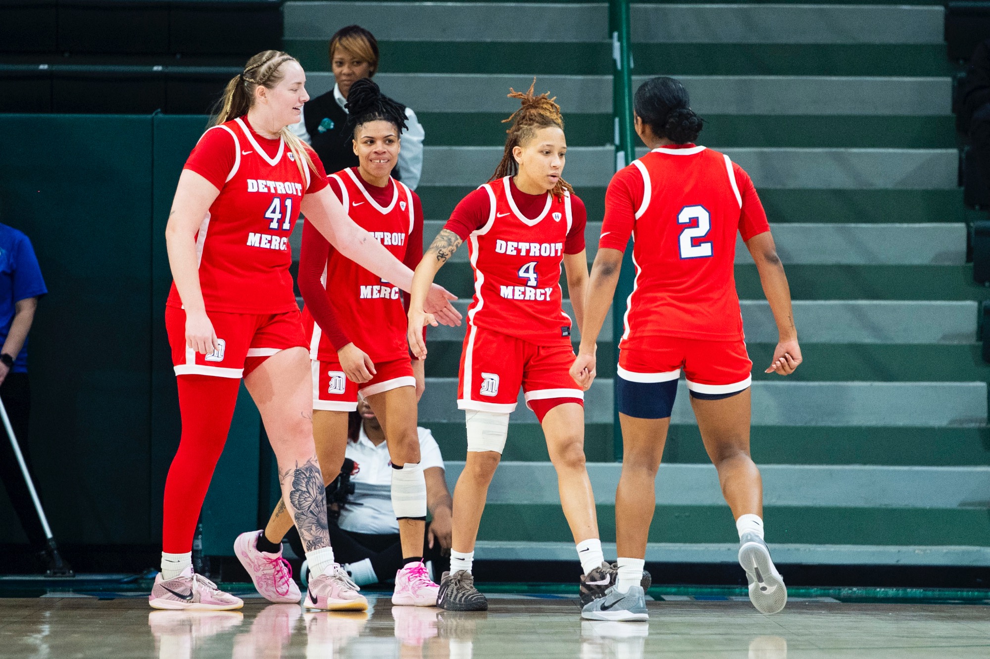 Myonna Hooper, senior guard (4), celebrates with teammates.