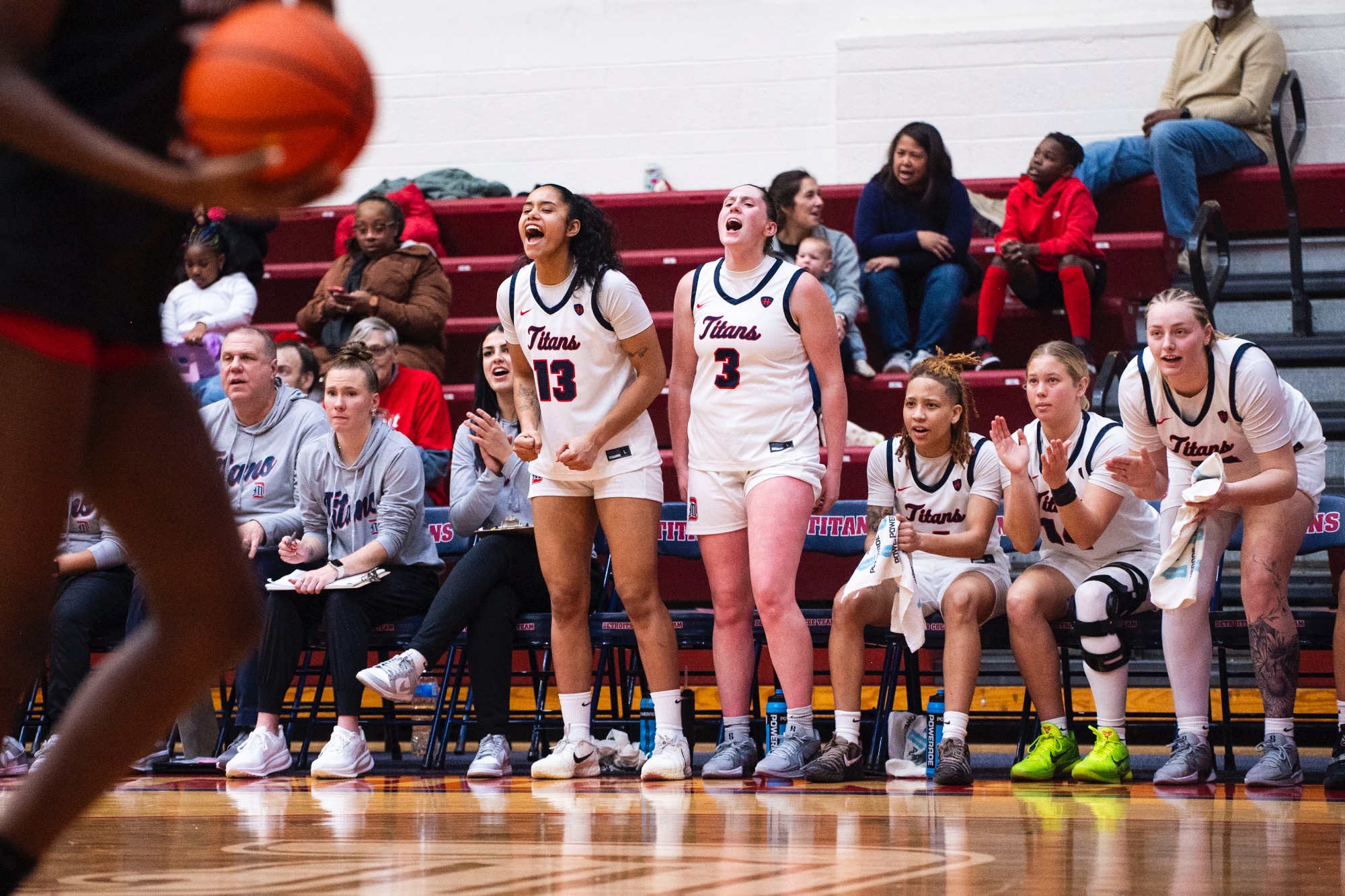 Brendha Schwartz, junior guard/forward, and Anna Lassan, sophomore forward, celebrate after a Titan basket.