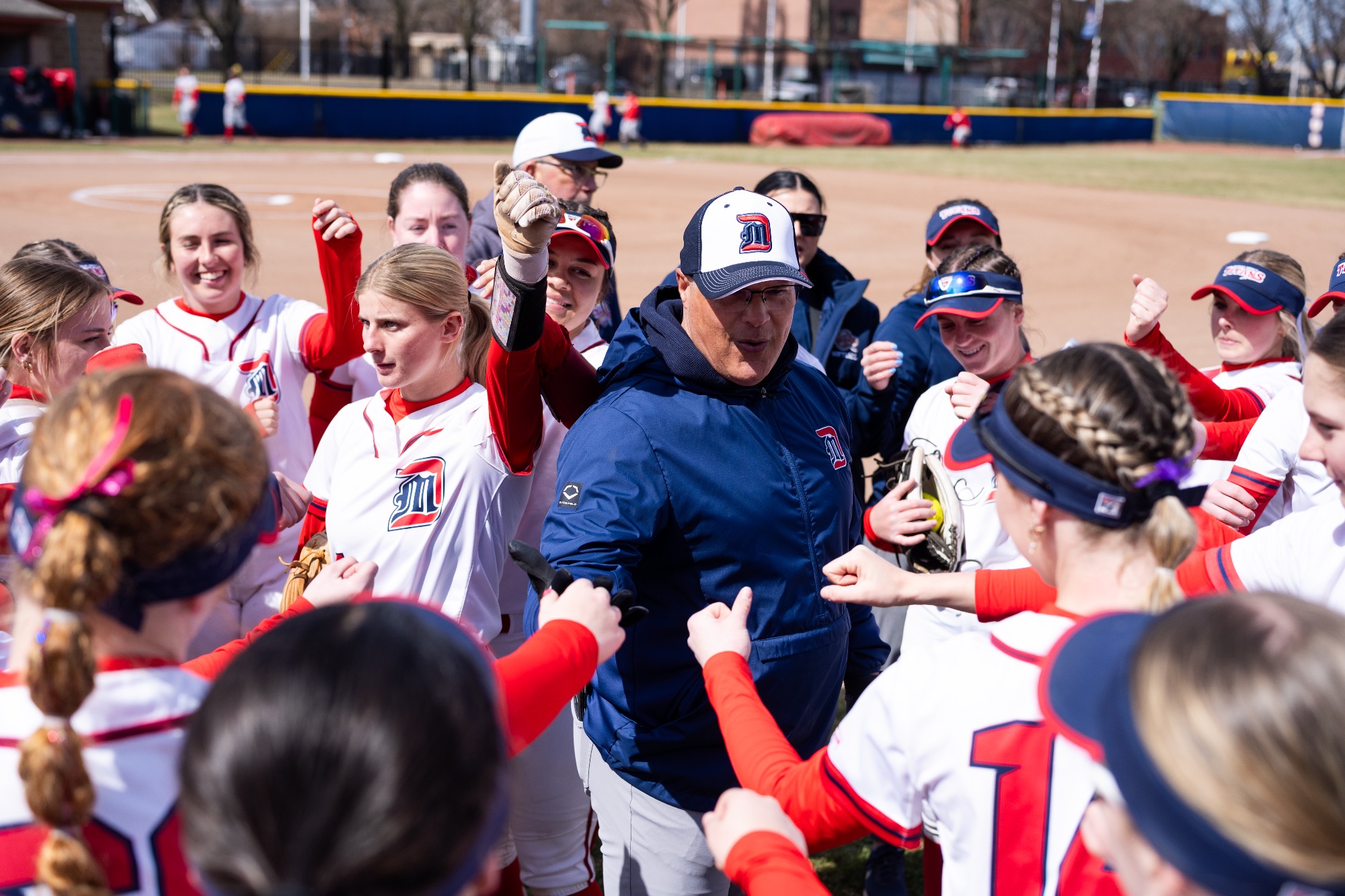 Head Coach Dan Vitale huddles with the team pregame.