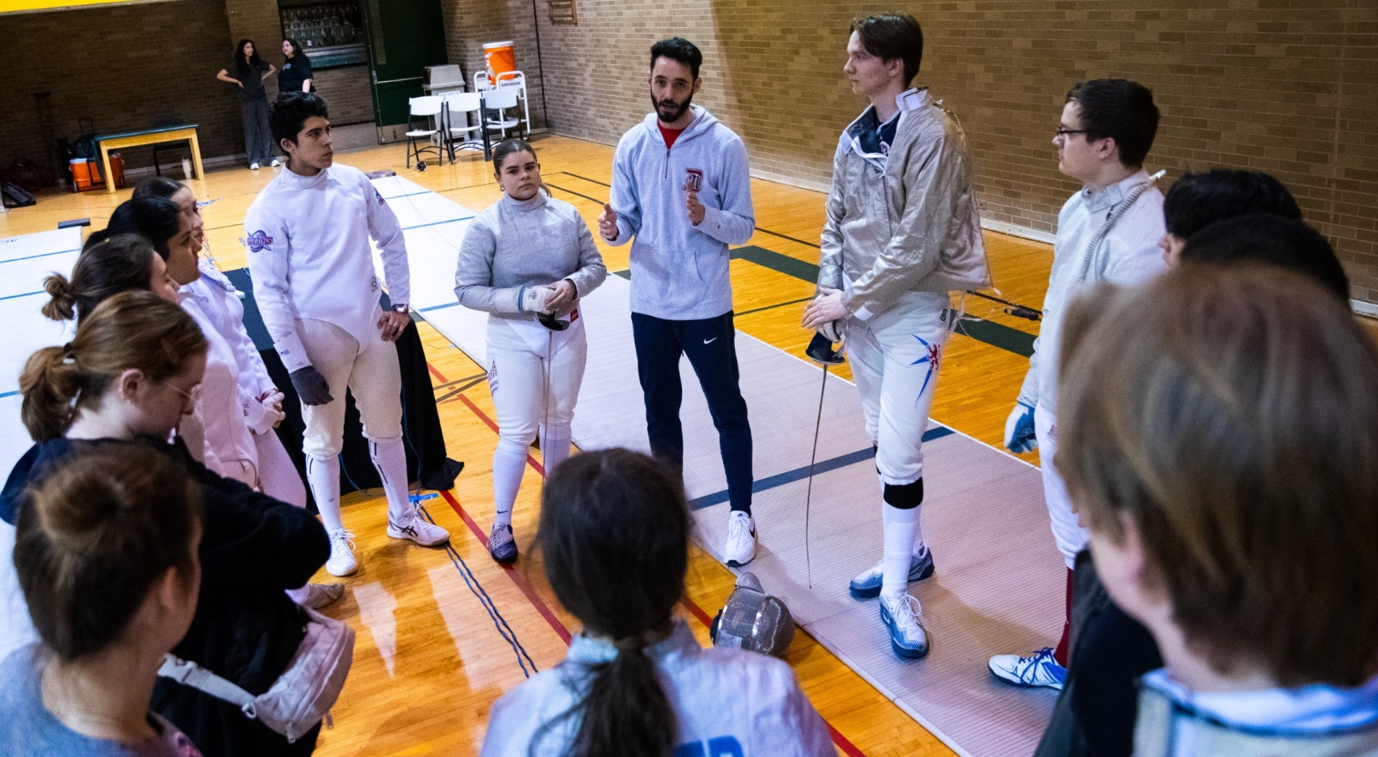 Michael Ramlow in Fencing Team Huddle
