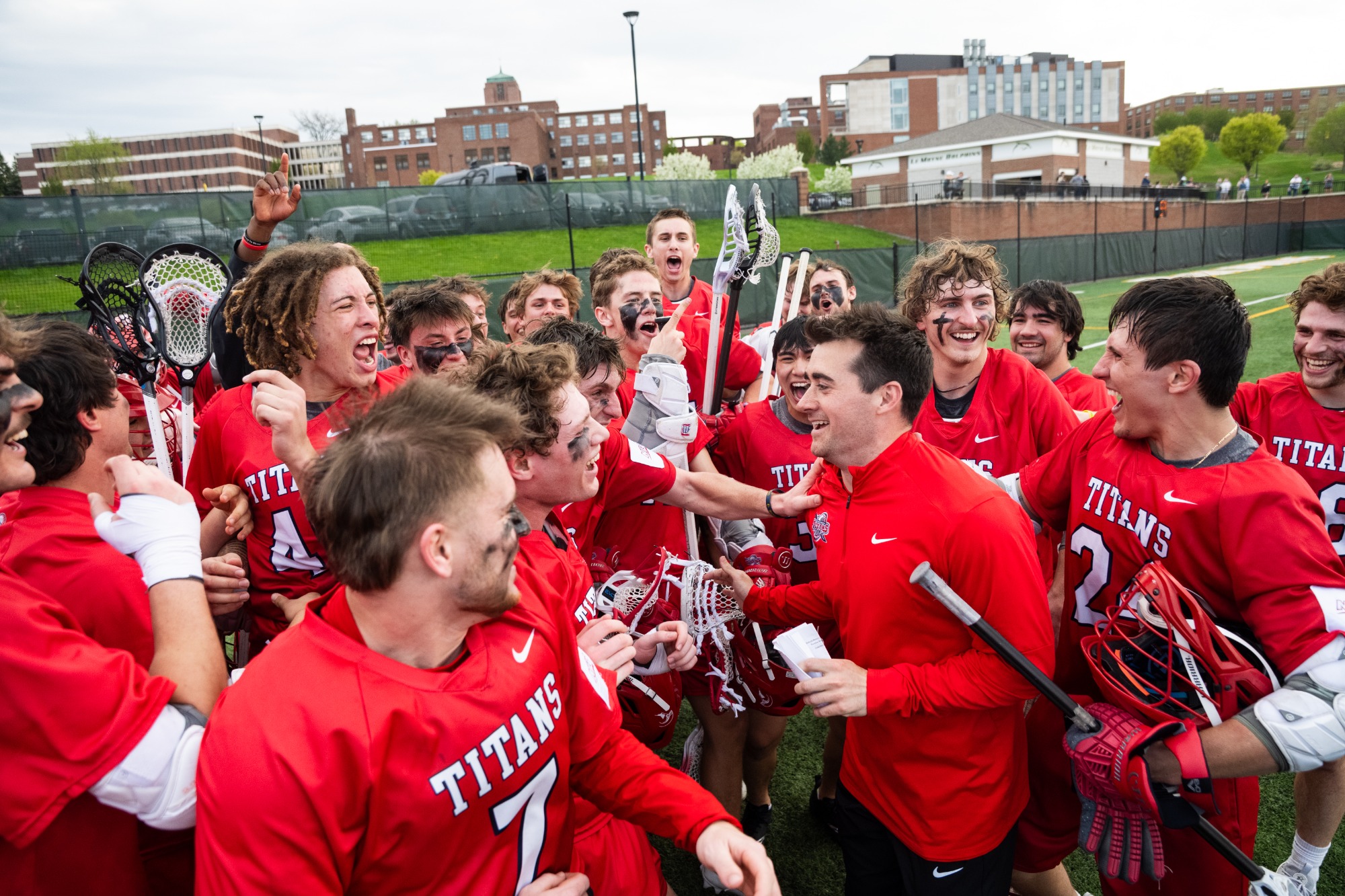 Head coach Charlie Hayes celebrates with the team