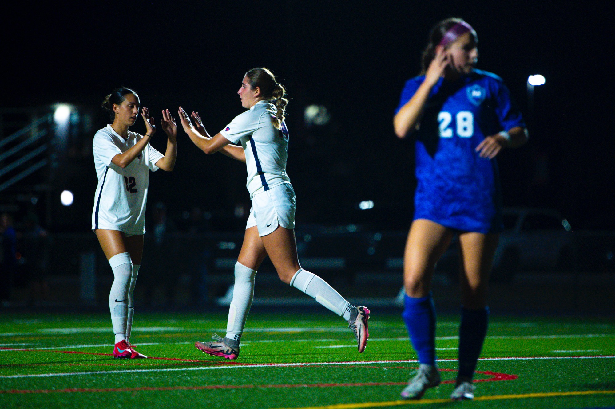 Camryn Pepper, sophomore midfielder, celebrates with Leila Lanier, junior defense.