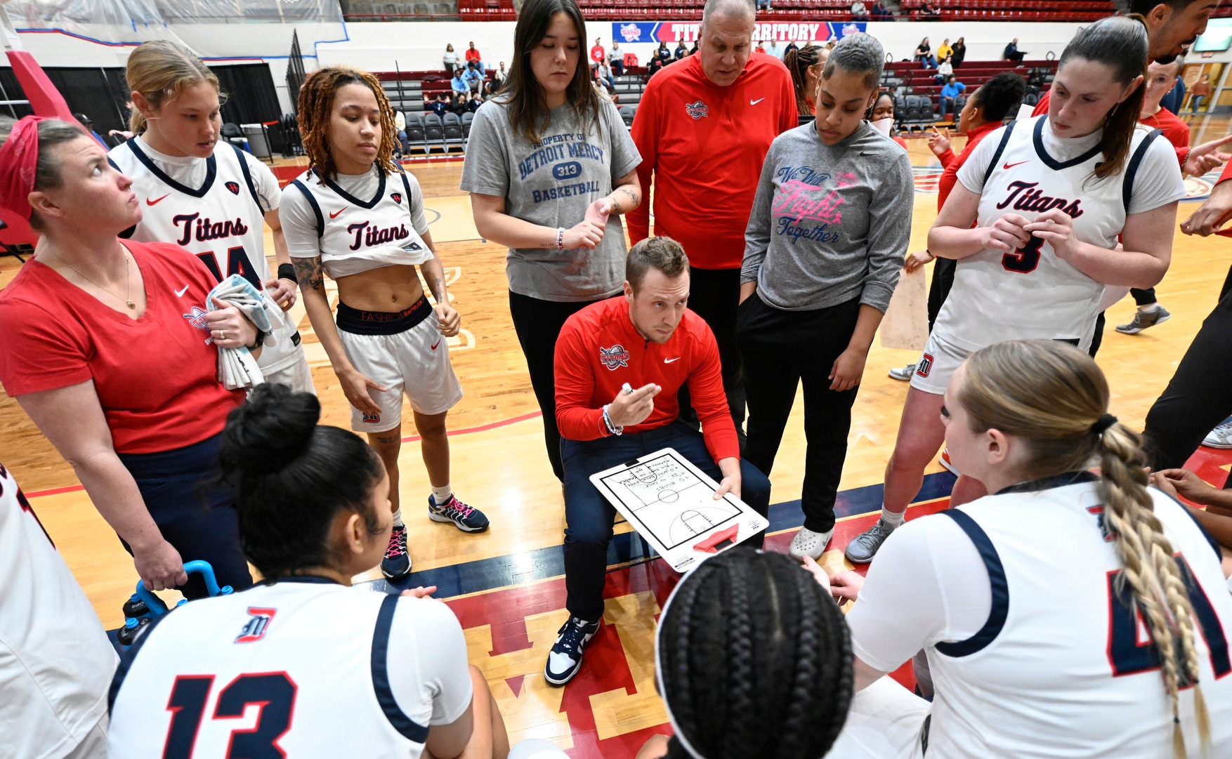 Head Coach Kiefer Haffey talks to the team during a timeout