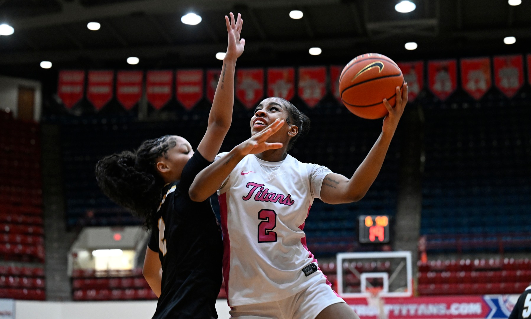 Makayla Jackson drive to the basket against a PFW defender
