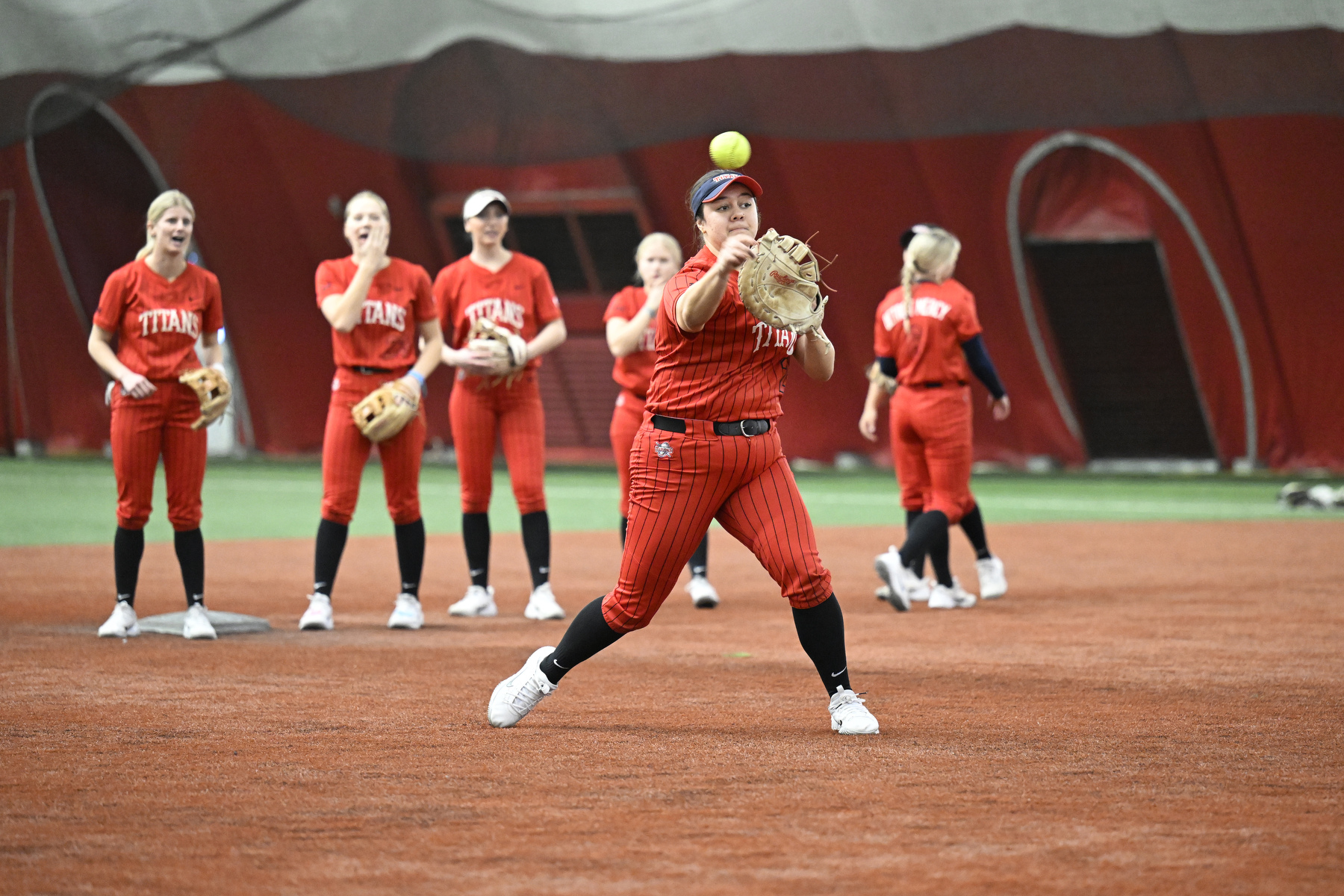 Detroit Mercy first baseman Claire Borg (25) fields grounders during warmups before a game against Valparaiso, Saturday, February 7, 2026, at The Dome at the Parkway Bank Sports Complex in Rosemont, IL.