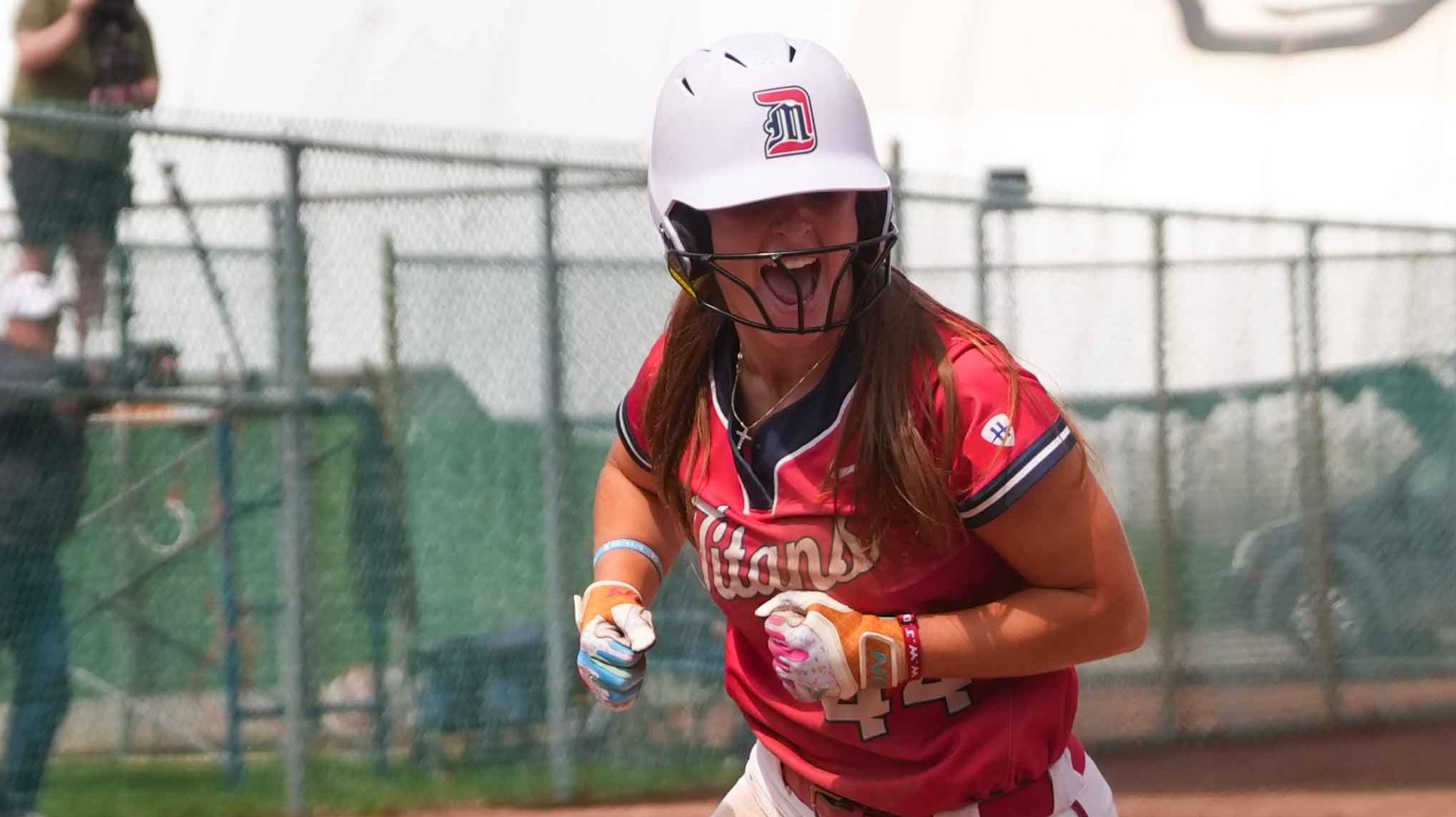 Liv Peterson celebrates scoring a run at the plate