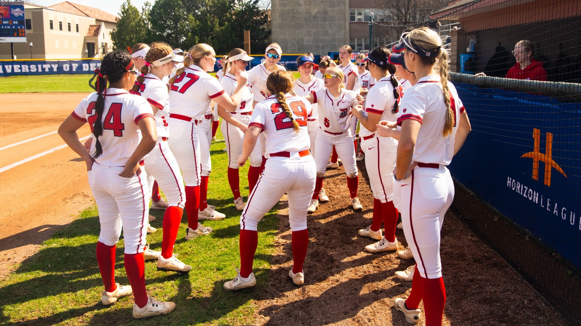 Softball team pre-game huddle at the dugout
