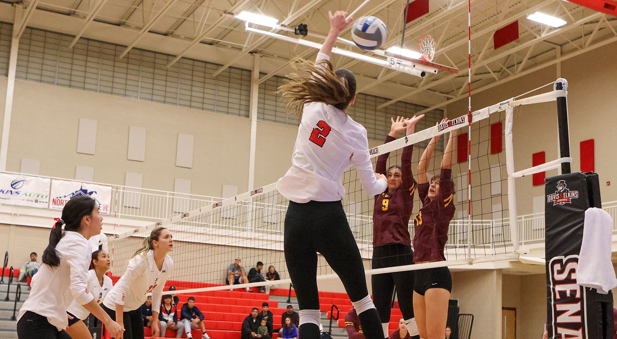 Melisa Ozsar spikes the volleyball over the net