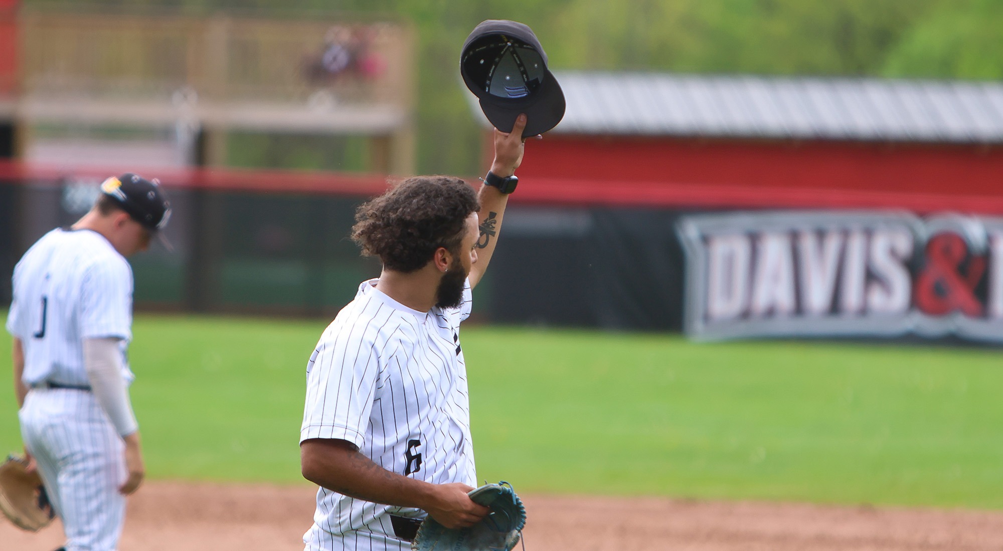Malachi Webb tips his cap to the outfield while walking off the mound for the final time
