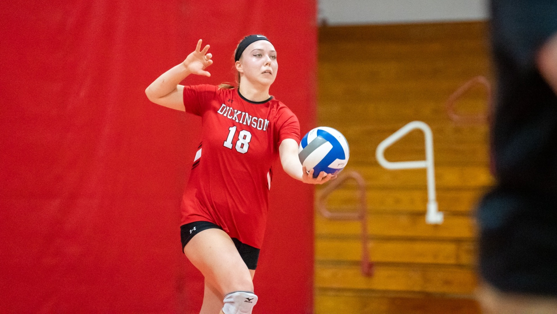 Alexa Barowski getting ready to serve against Johns Hopkins University on 11-6-24
