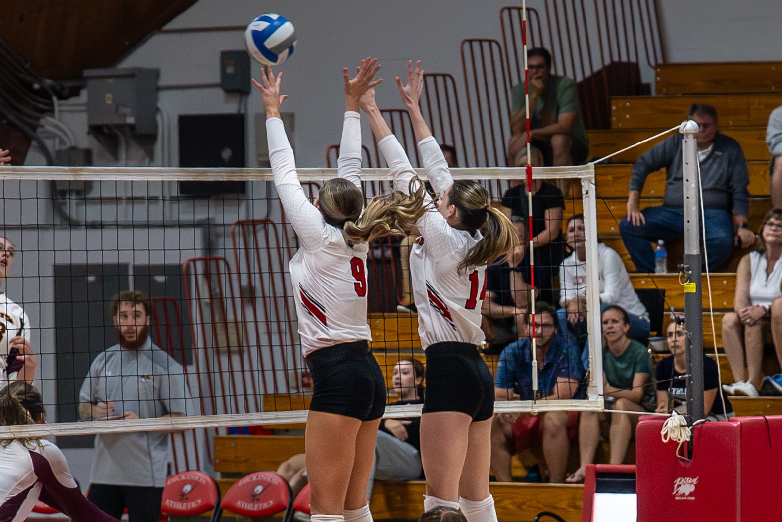 Caroline Cusson and Jessica Currie going up for a block against Salisbury University on 9-26-25