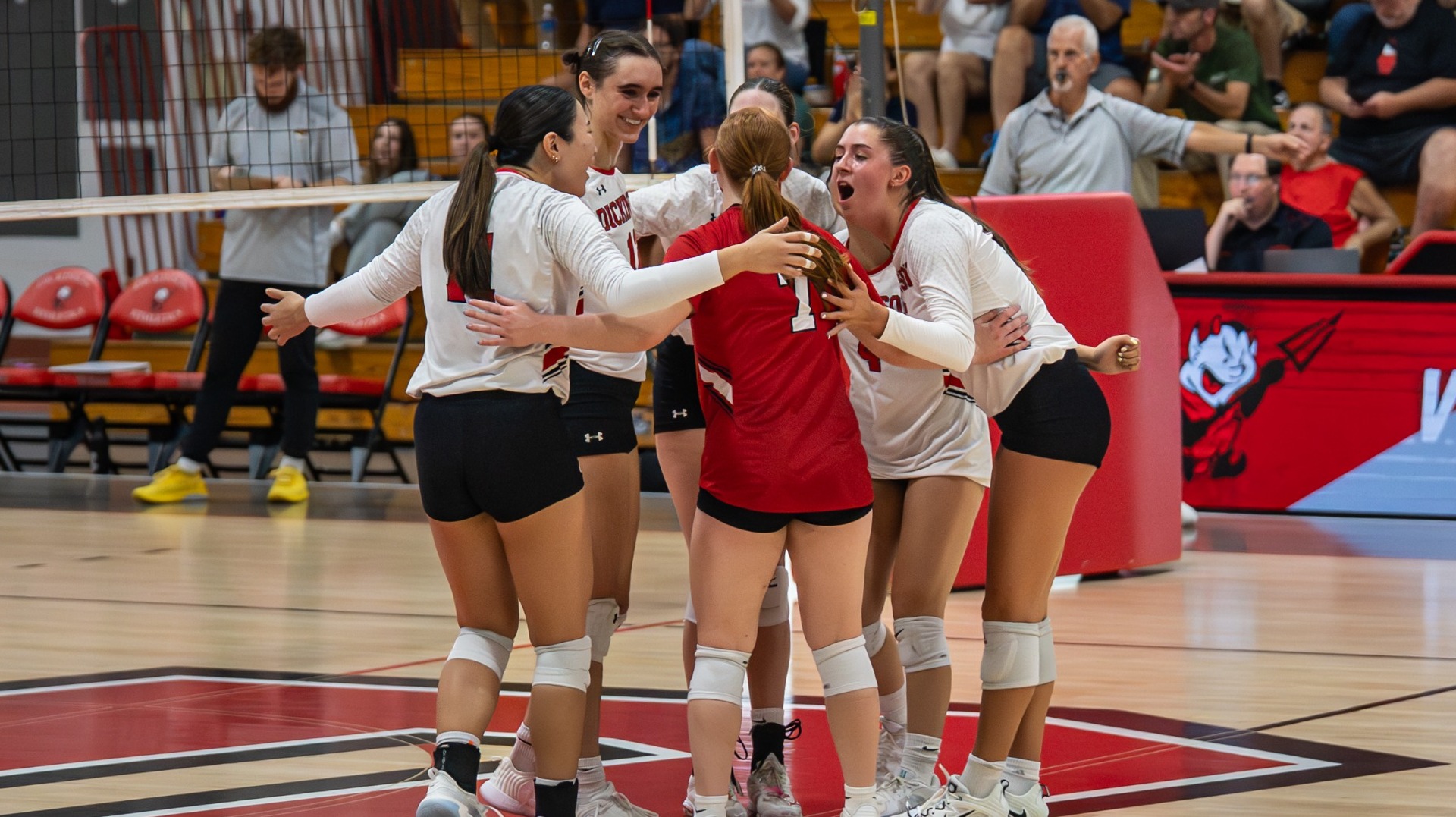 Dickinson volleyball team celebrating a point against Salisbury University on 9-26-25