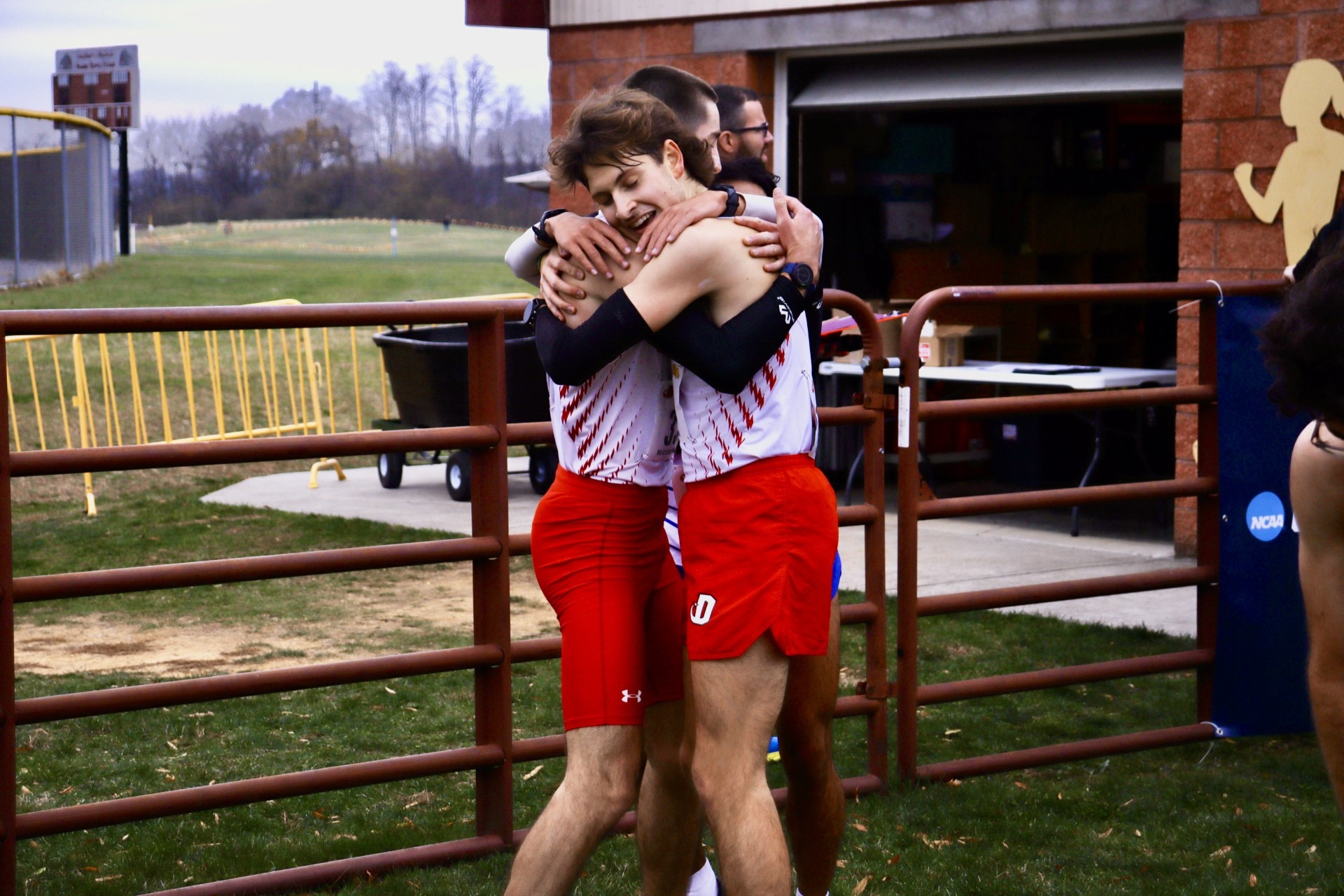 Luke Knestout and Nate Caldwell hug after their strong finishes in the XC NCAA Regional