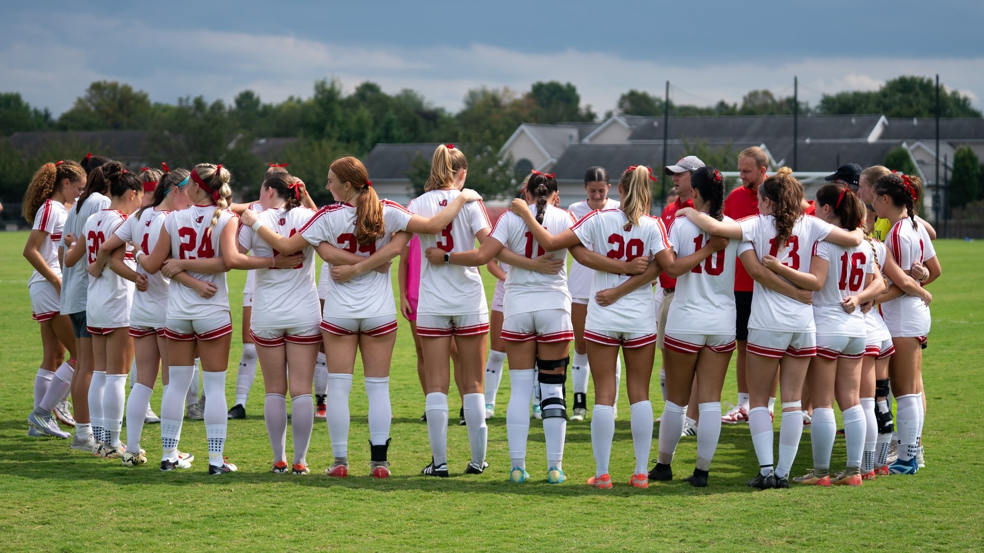 Women's soccer team huddle pregame against Bridgewater College during the 2025 season