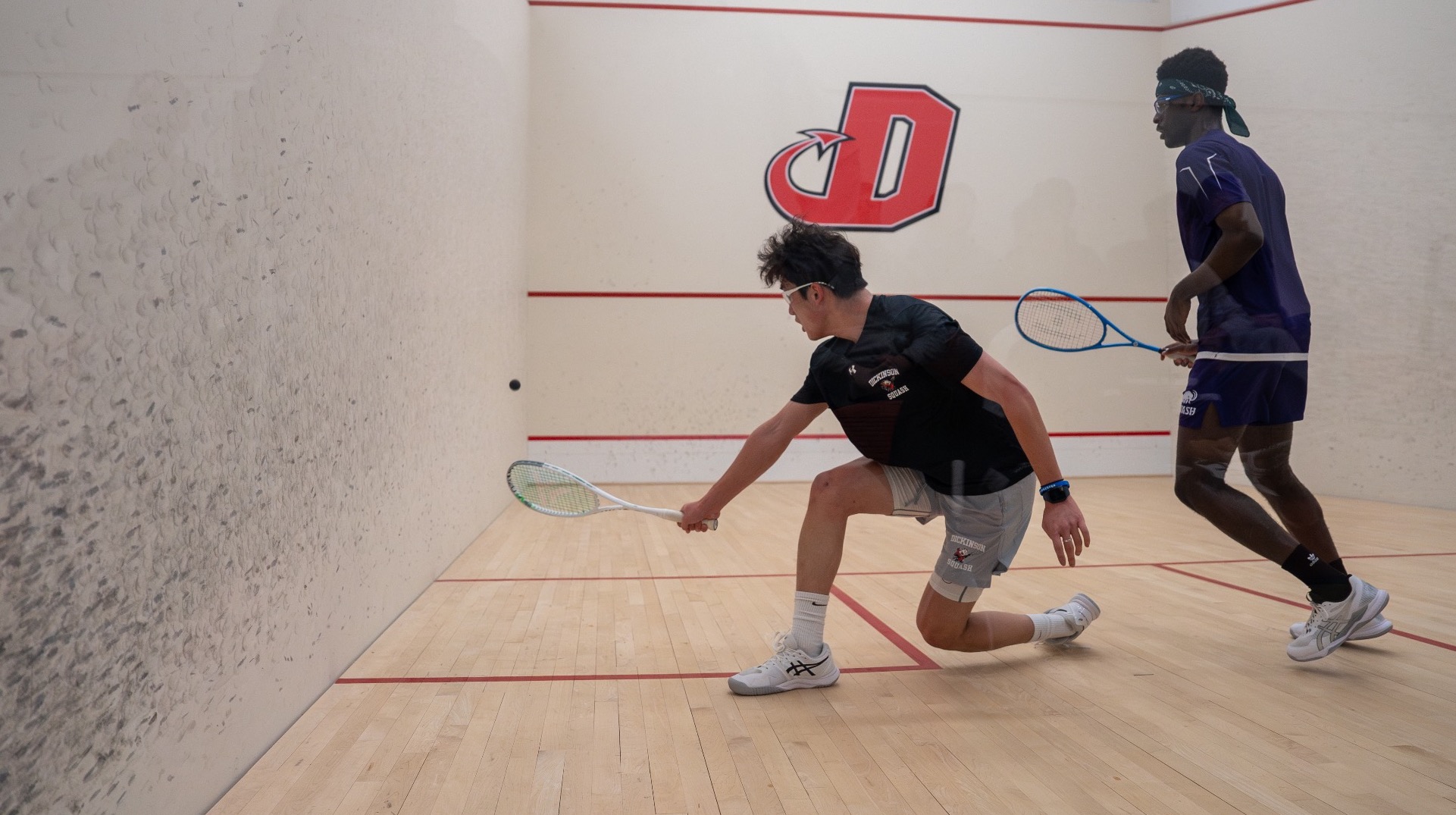 Men’s squash player going for a forehand shot during the 2024-2025 season