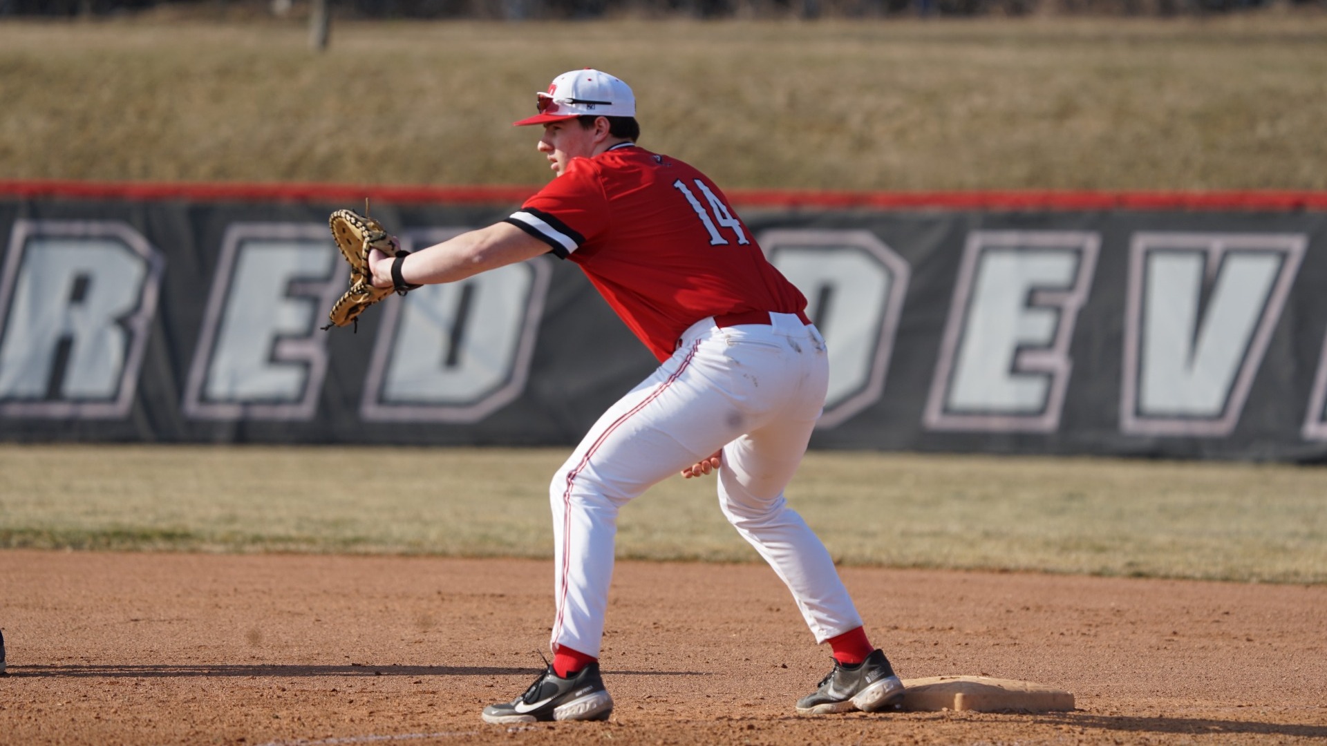 Kevin Schmidt waiting for a throw at first base against Messiah University on 3-4-25