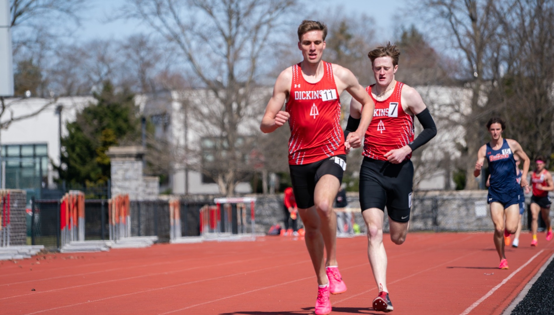 Two men's track athletes competing at the Little Three Championship during the 2025 spring season
