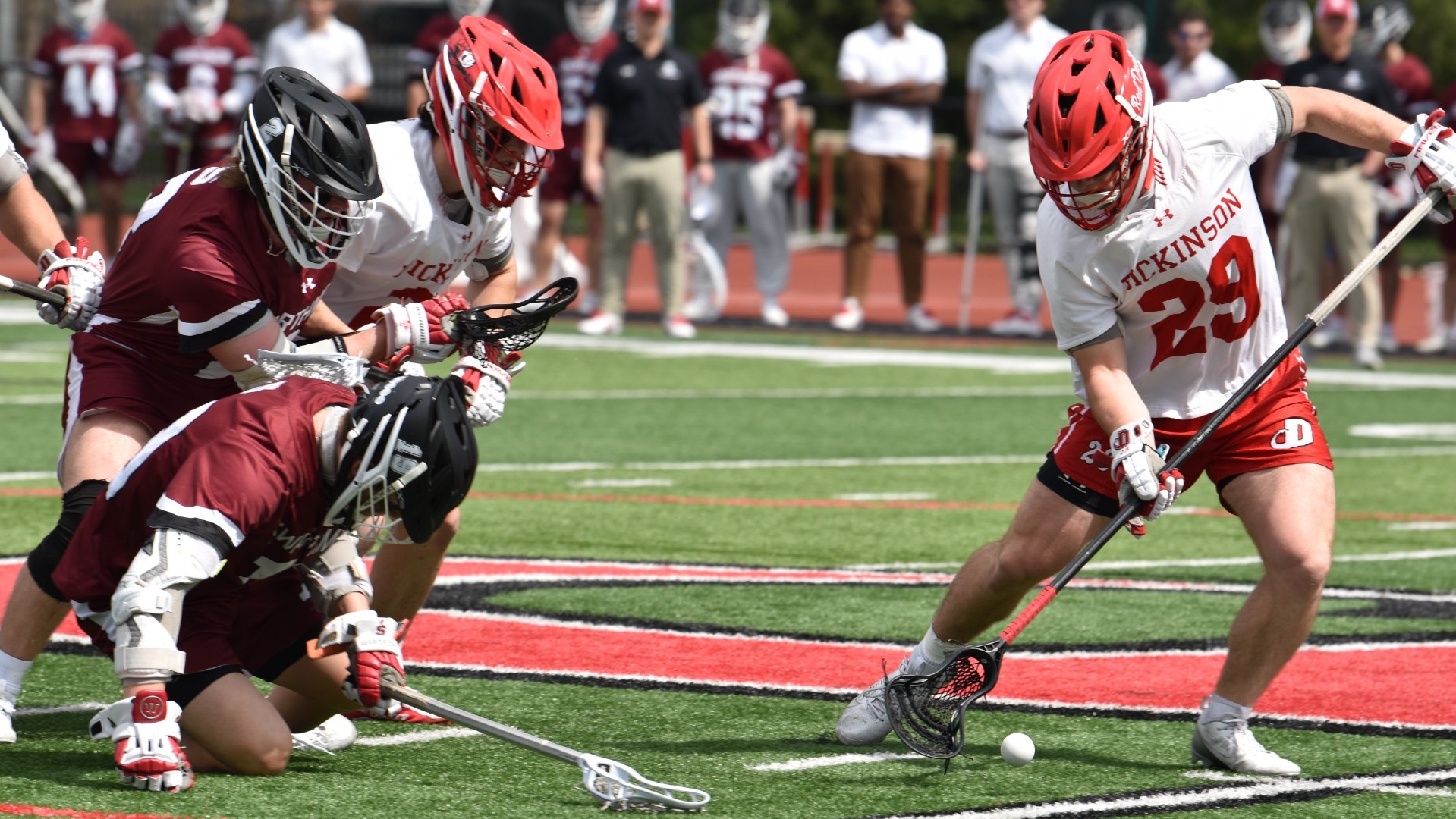 Ethan Ferrant digging up a groundball off a faceoff win against Swarthmore College on 3-29-25