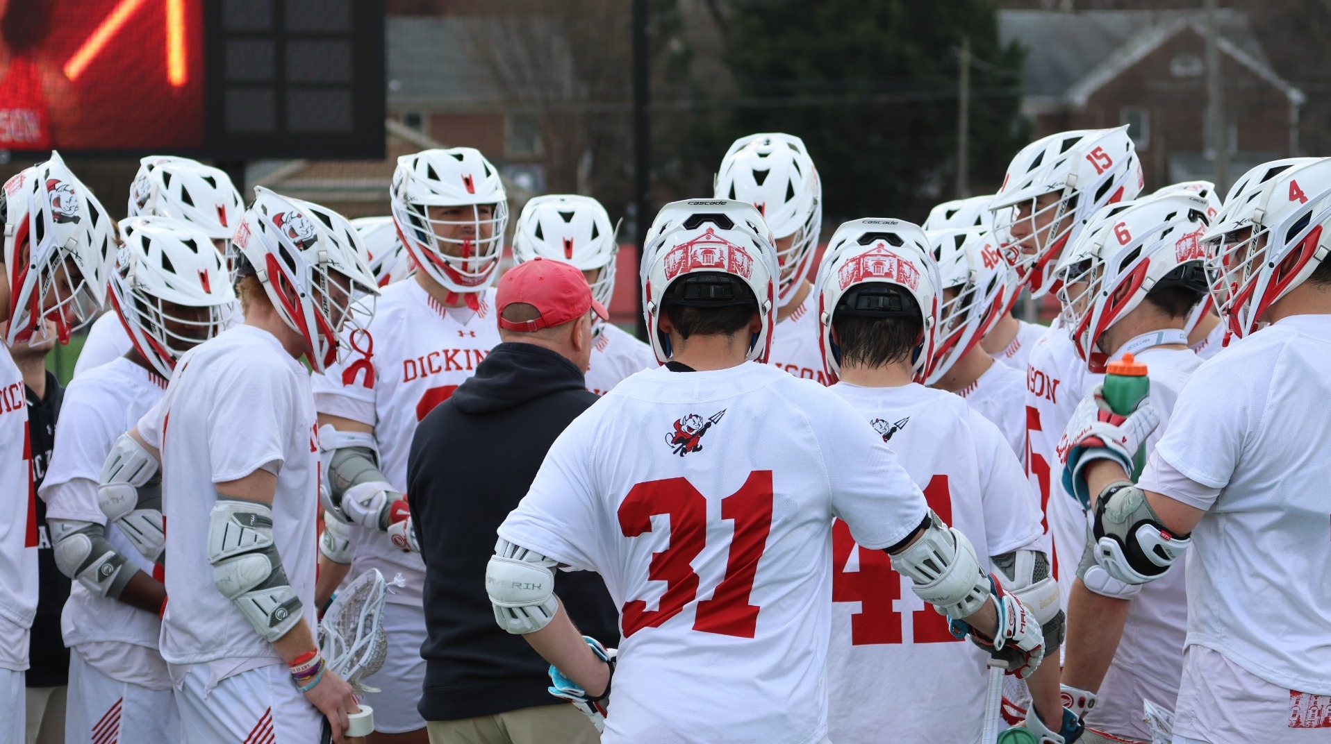 Men's lacrosse team huddle against Washington College during the 2025 season