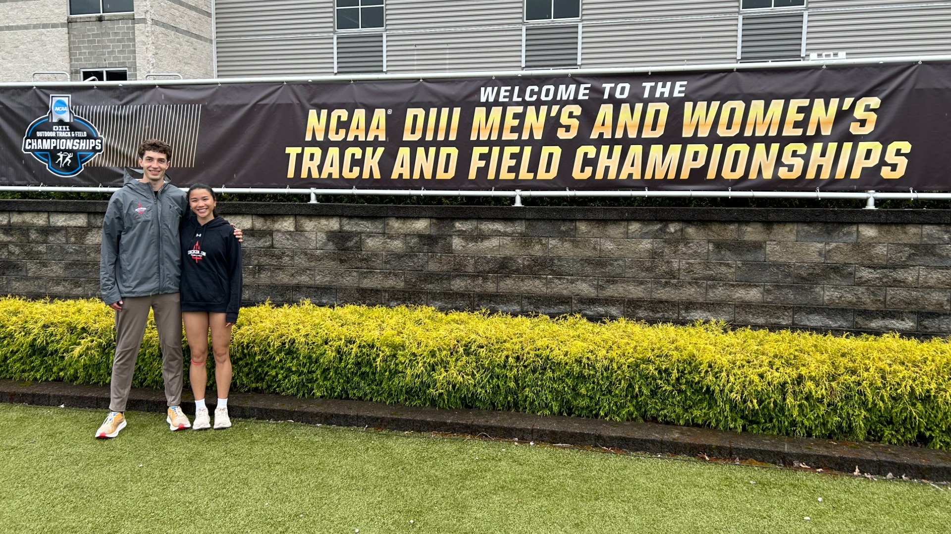 Annie Leder and Trevor Richwine standing outside the gates at the NCAA Division III Outdoor Track and Field Championships 5-21-25 (2)