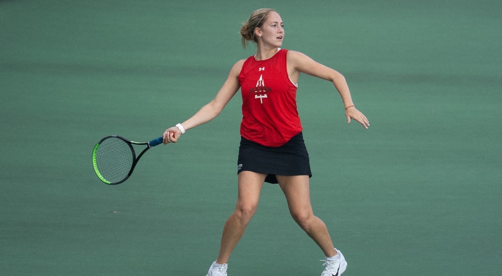 Chloe Heller hitting a forehand against Catholic University during the 2025 fall season