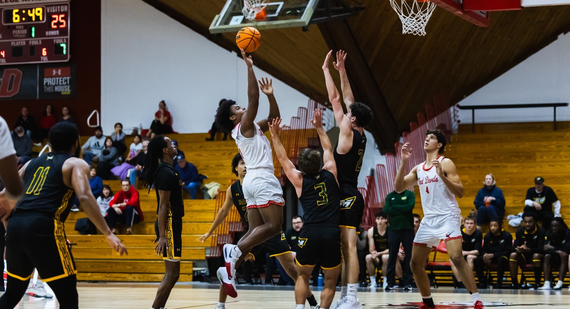 Isaiah Edmond going for a driving layup against McDaniel College on 1-14-26