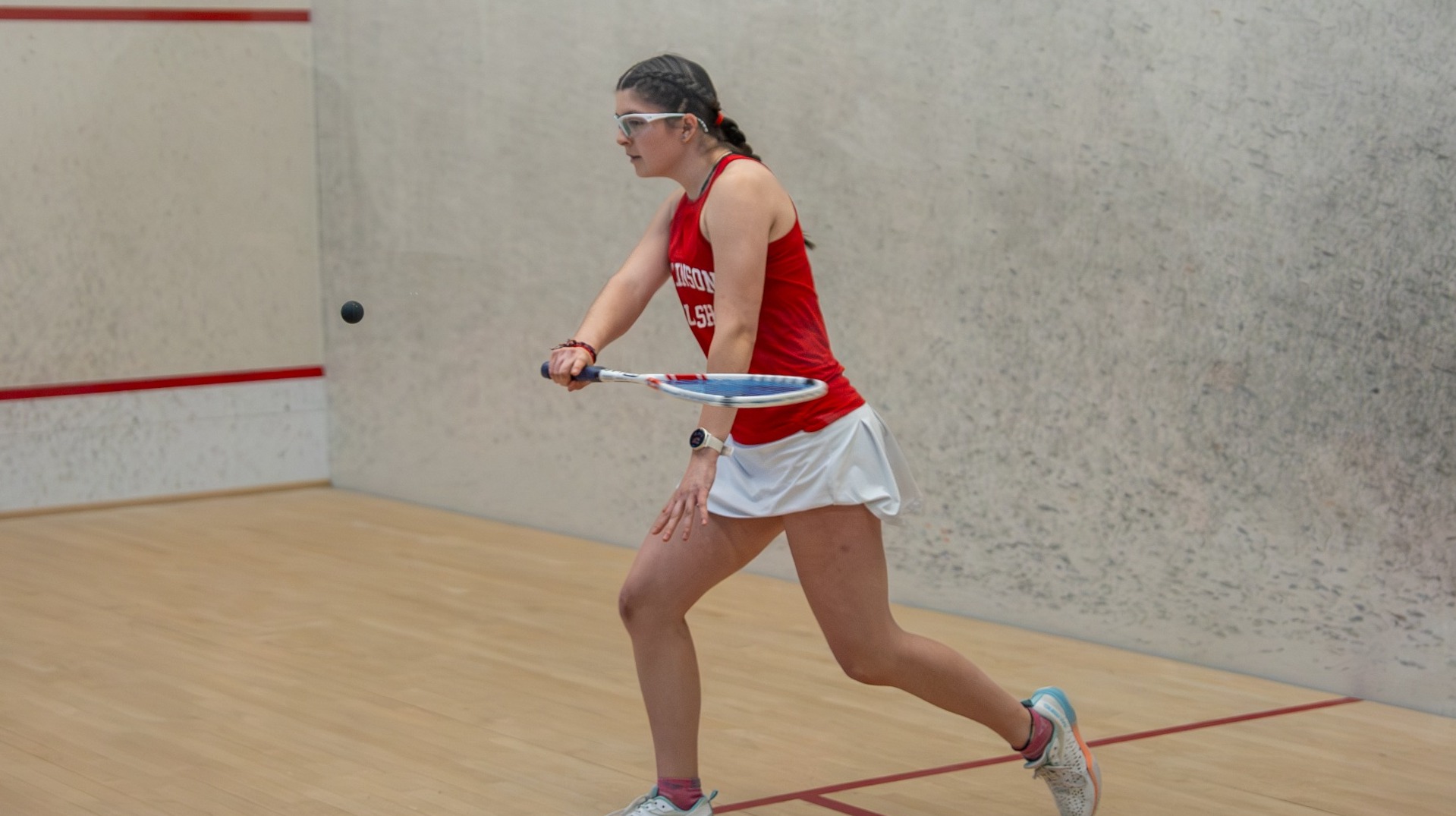 Anabel Romero going for a backhand shot against Vassar College on 1-17-26