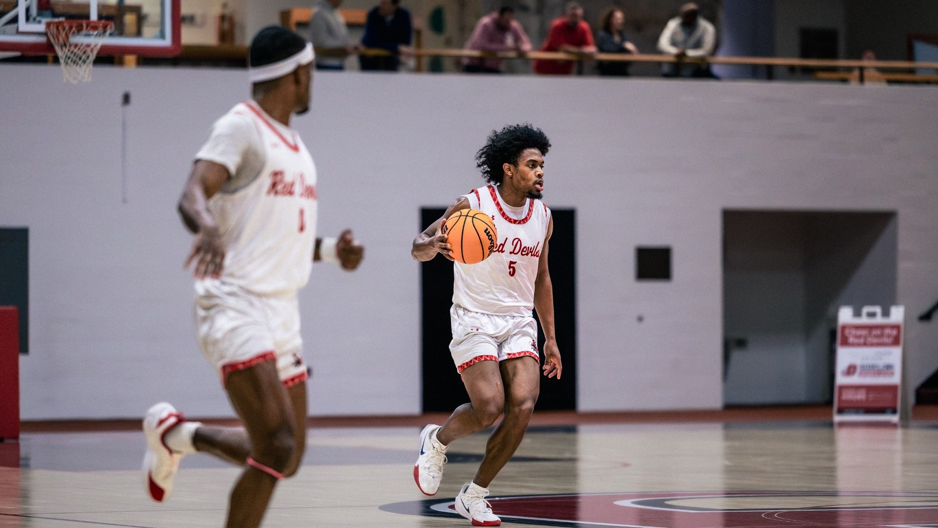 Isaiah Edmond dribbling the ball down the court against McDaniel College on 1-14-26