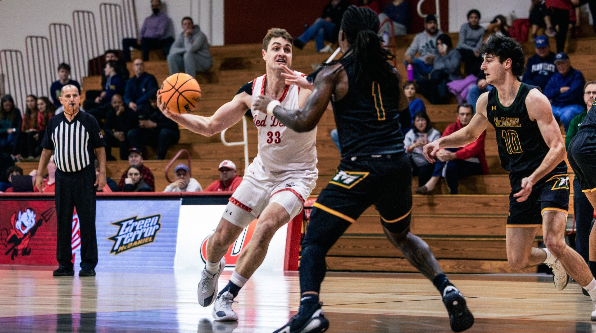 Dane Moran dribbling down into the paint against McDaniel College on 1-14-26