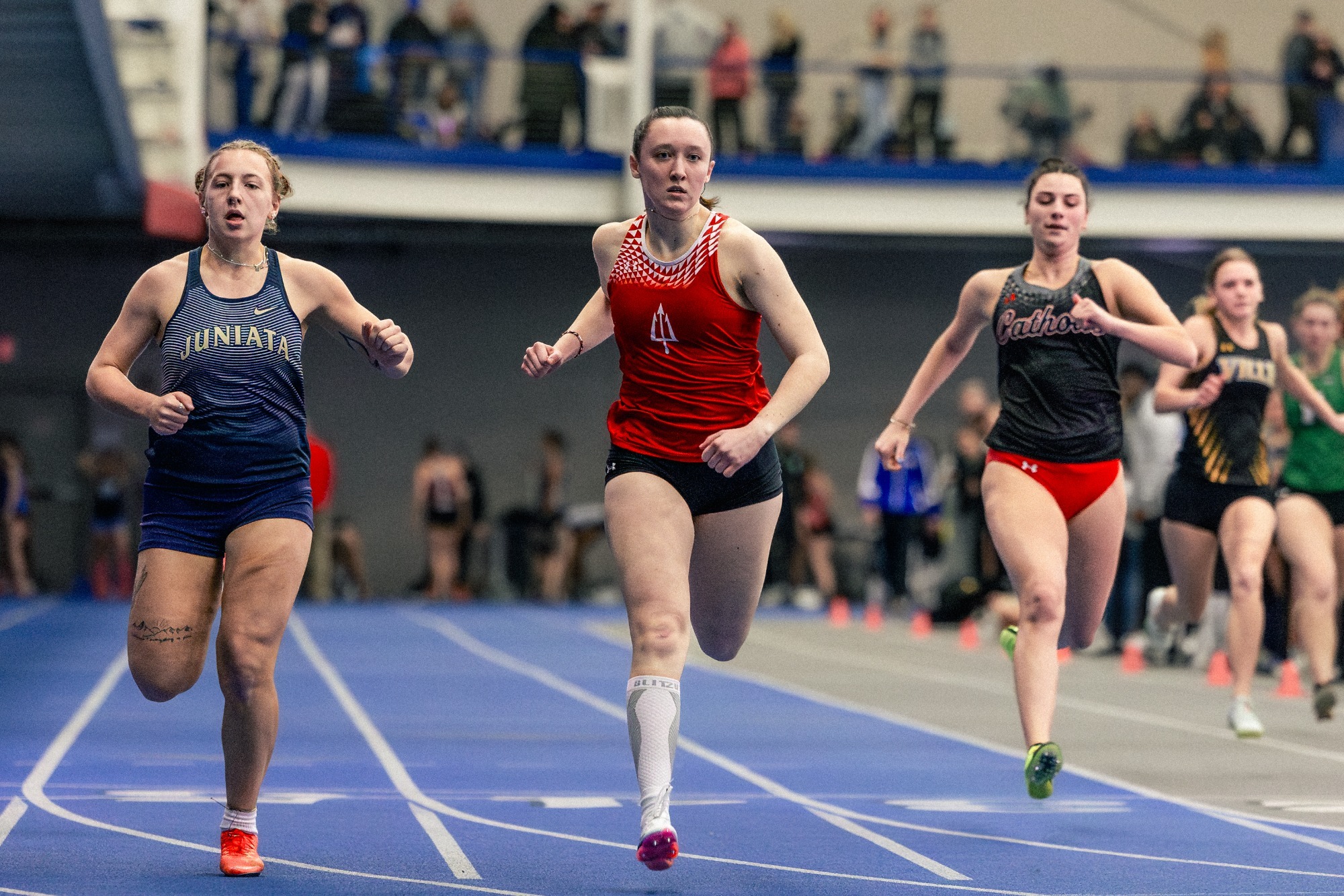 Track and Field runner Erin Olsavsky crosses the finish line