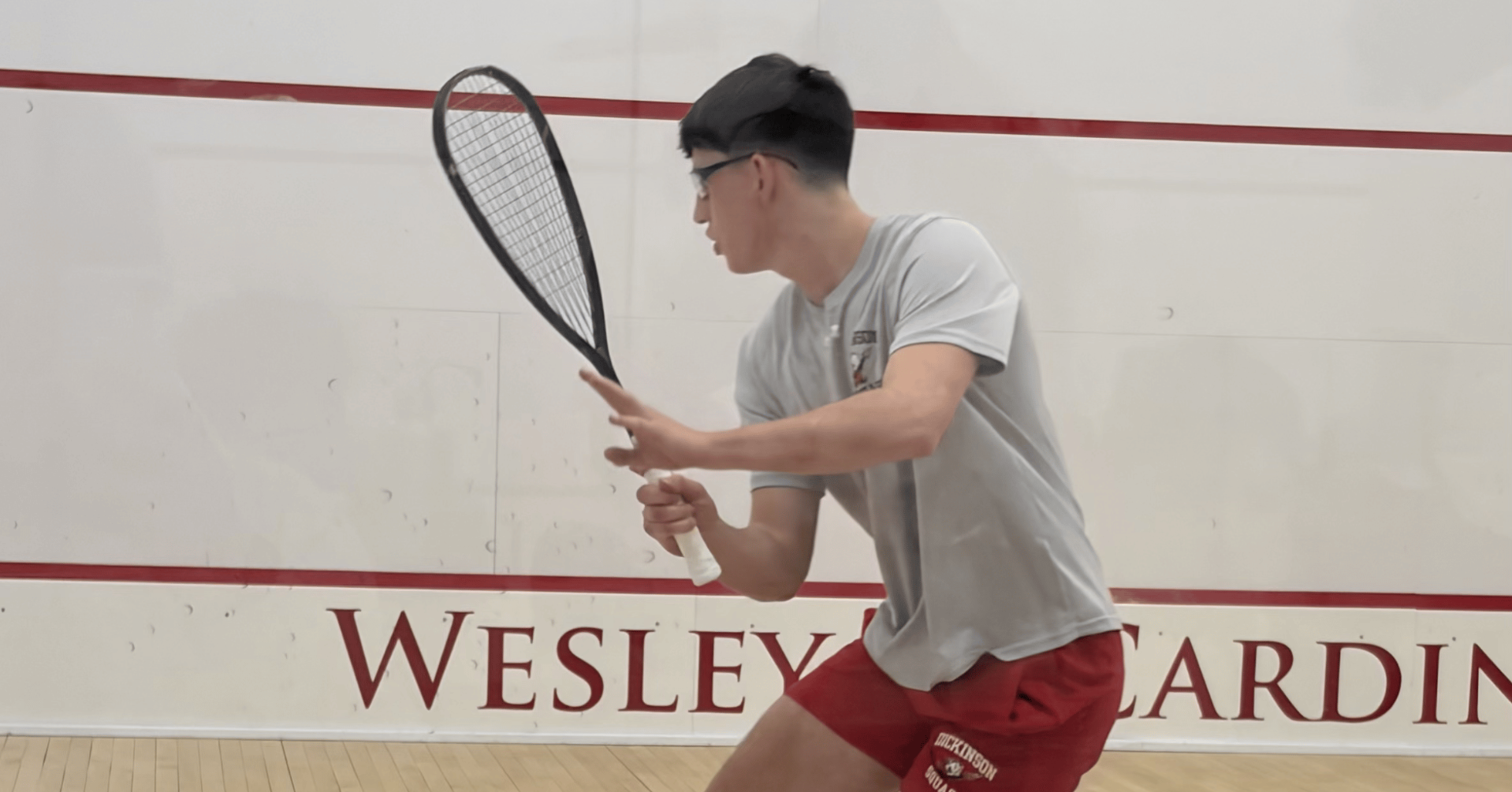 Men's squash player going for a forehand against Wesleyan University on 1-8-26