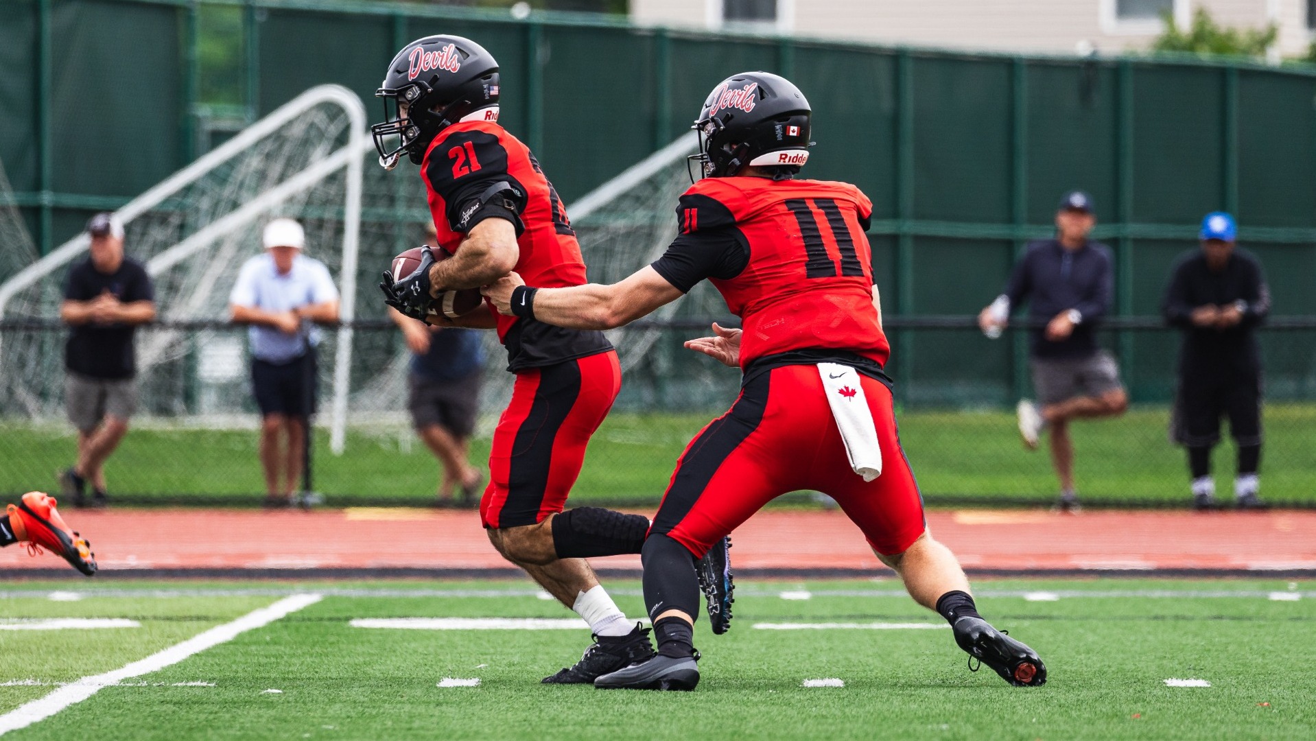 Ben Klassen handing off the ball to Jake Williams against Lycoming College on 9-19-26