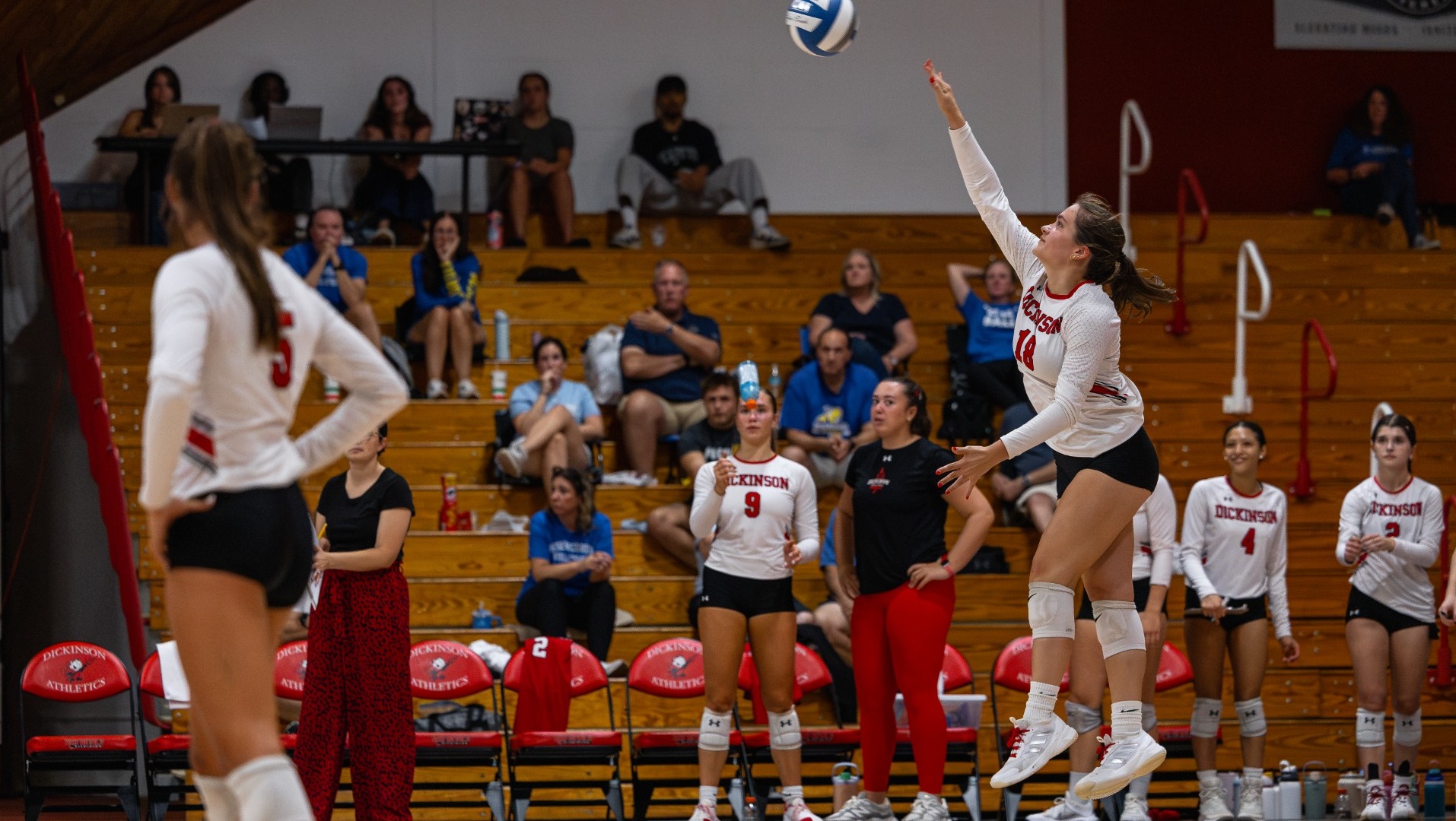 Brenna Williams going for a serve against Misericordia University on 9-12-26