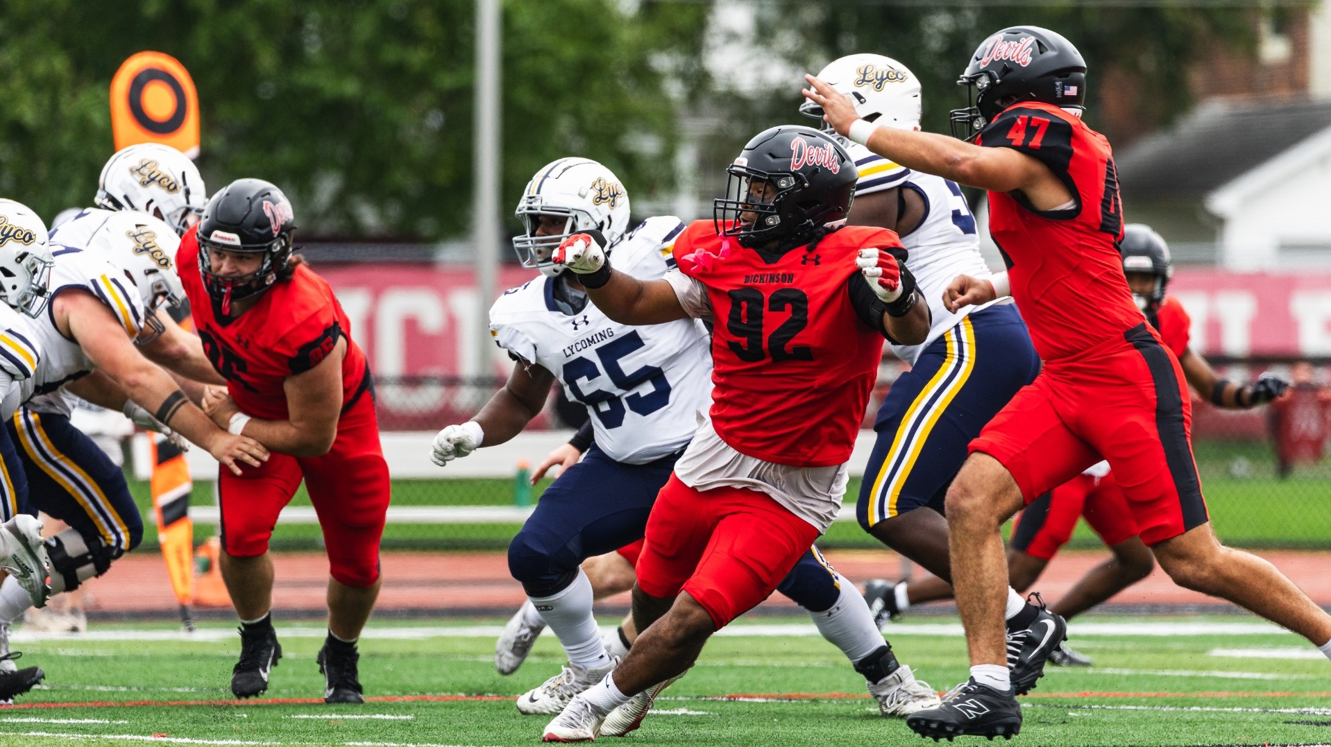 Joaquin Acuna and Domani White chasing the Lycoming College ball carrier on 9-19-26
