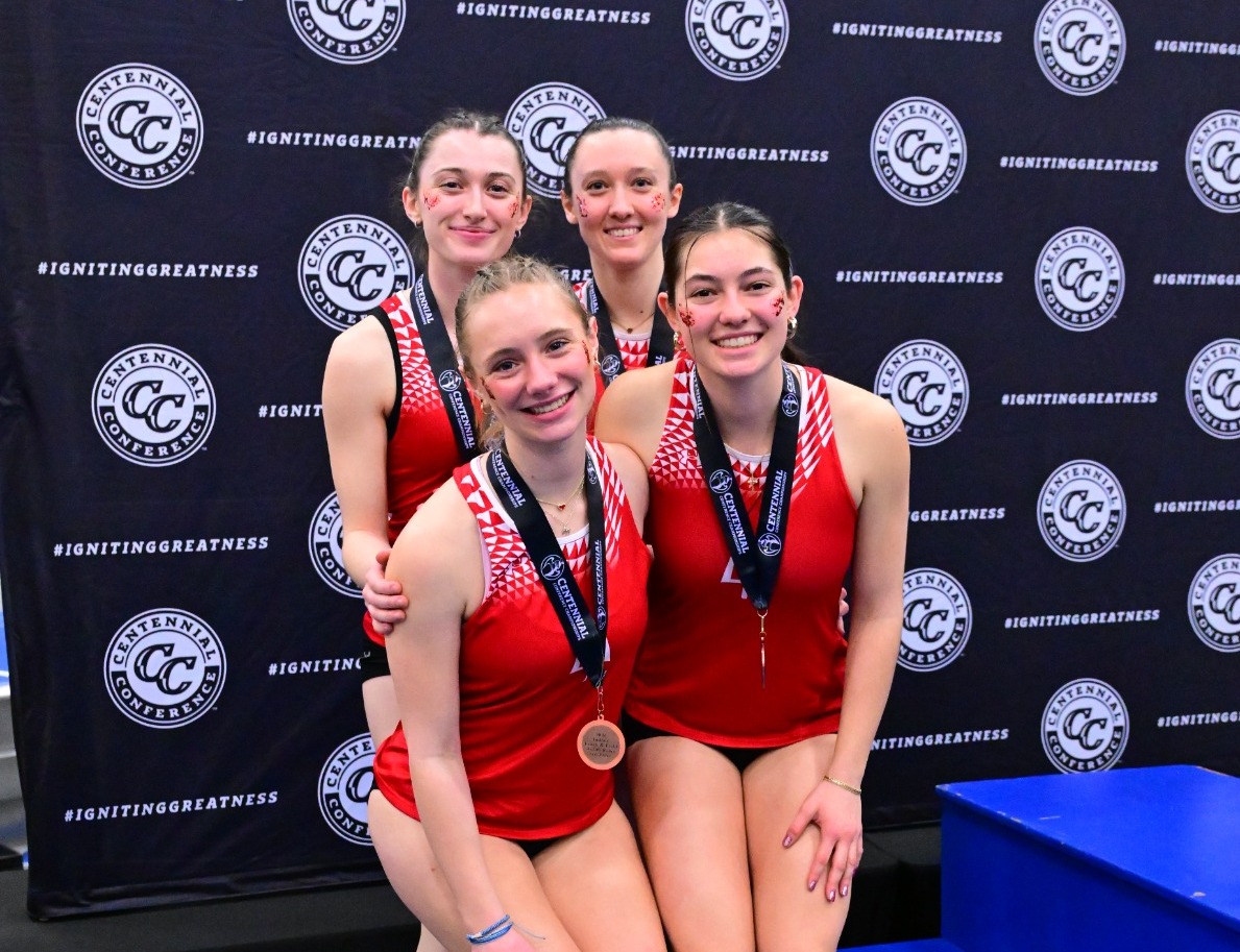 Women's track and field relay team on the podium at 2026 Indoor Conference Championships