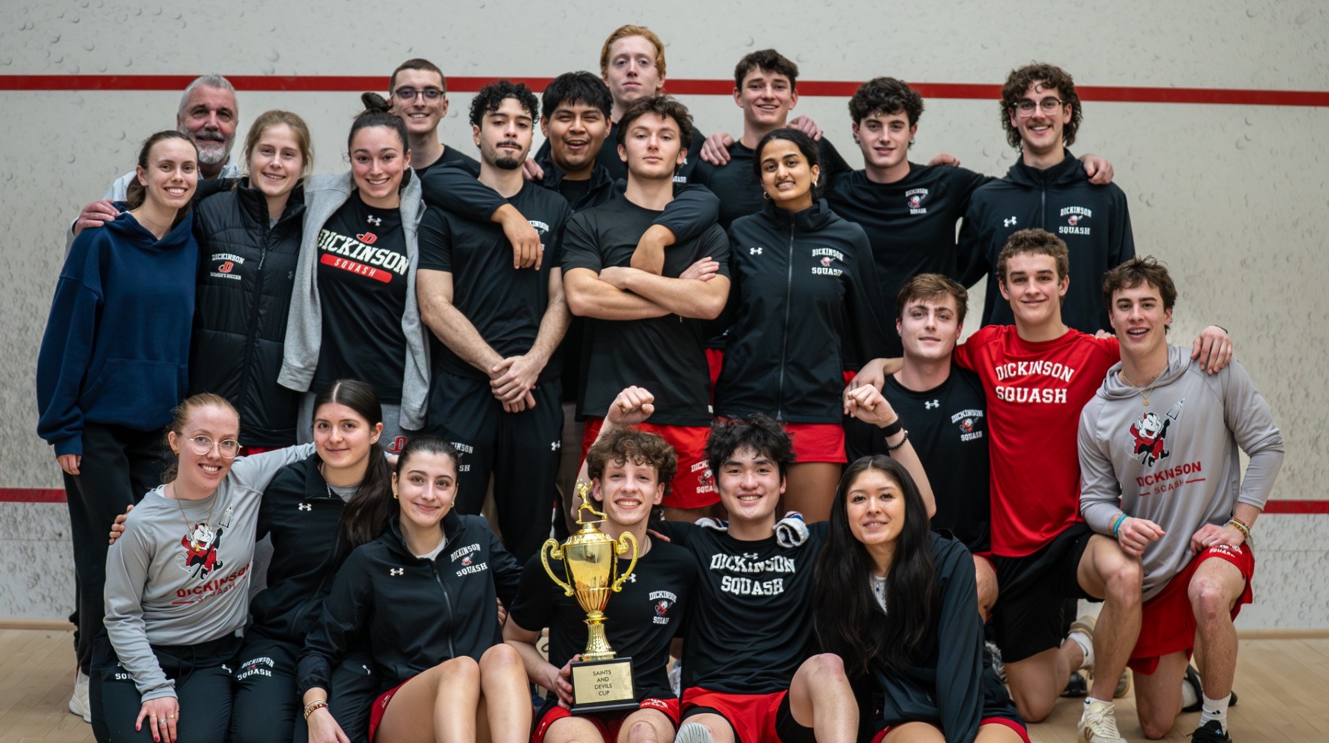 Both squash teams taking a group photo after the men beat St. Lawrence on 2-6-26 to win the Devil-Saints cup