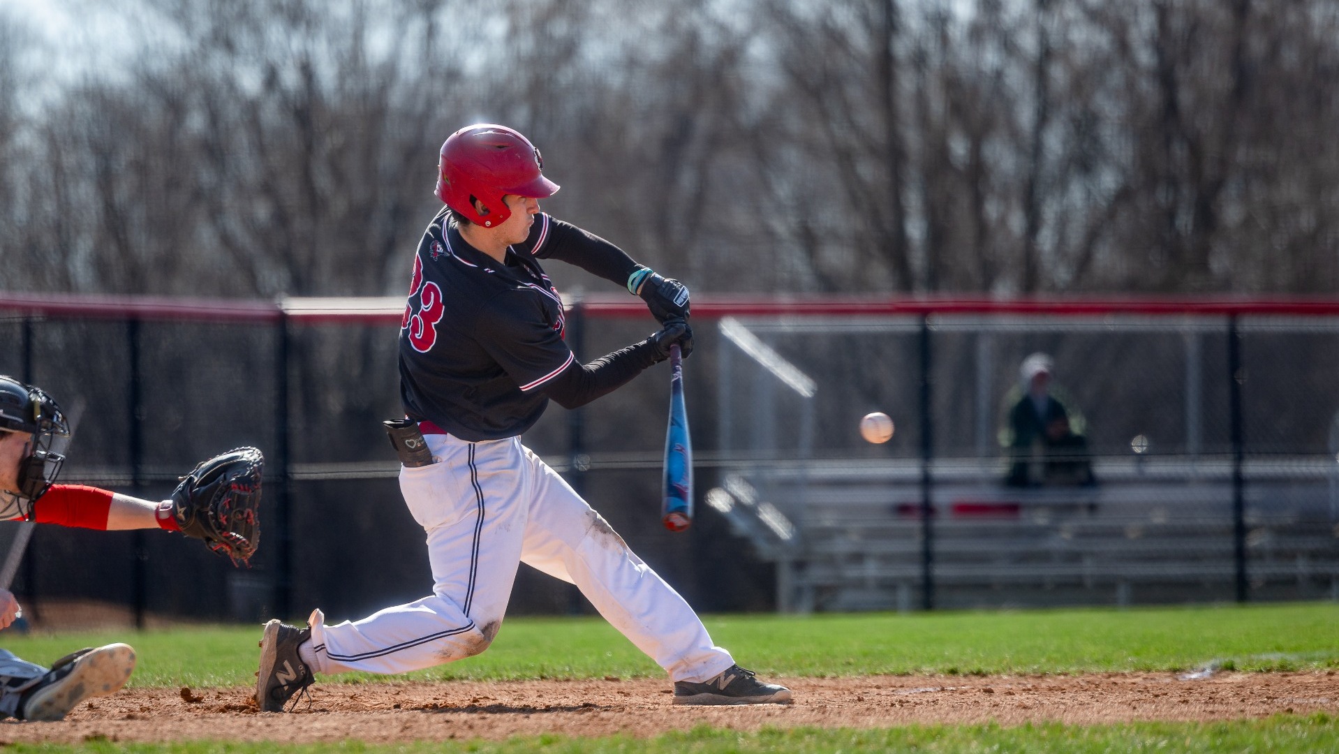 Luke Gartland swinging at a pitch against St. Lawrence University on 3-24-26
