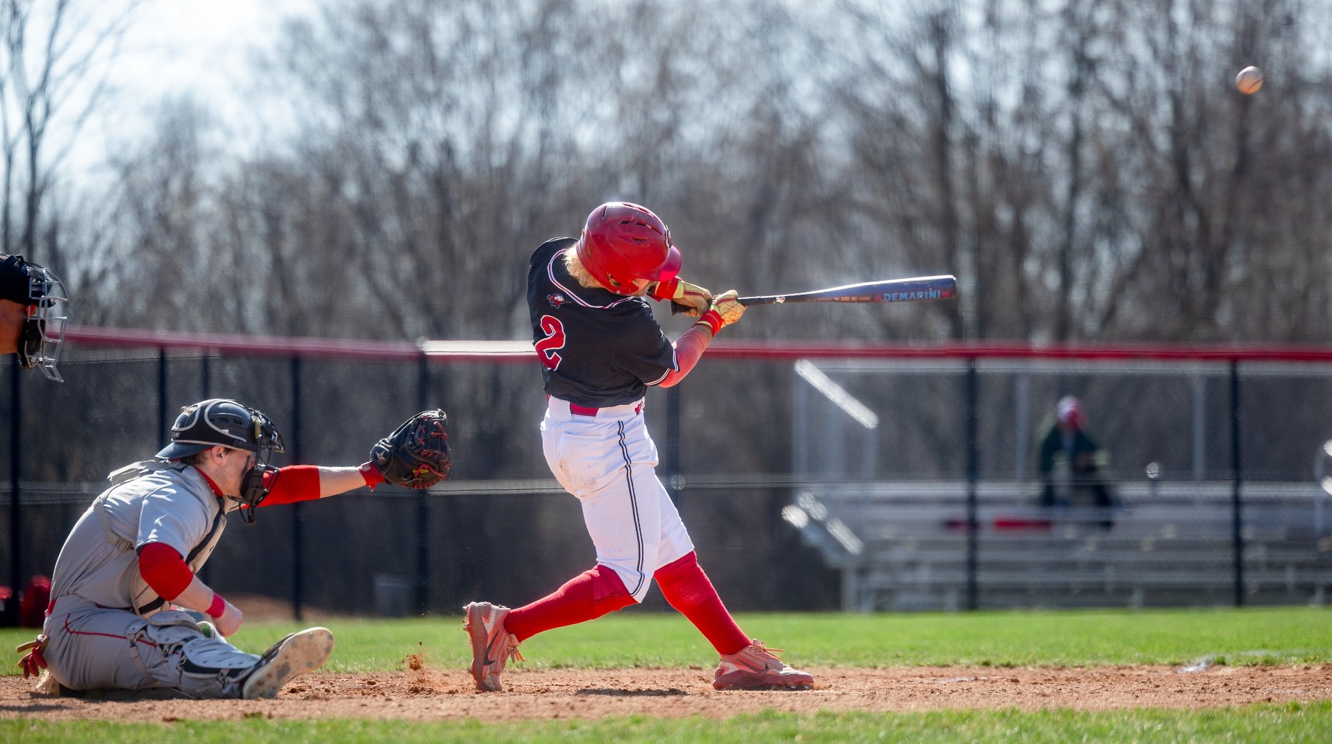 Dylan Posencheg swinging at a pitch against St. Lawrence University on 3-24-26
