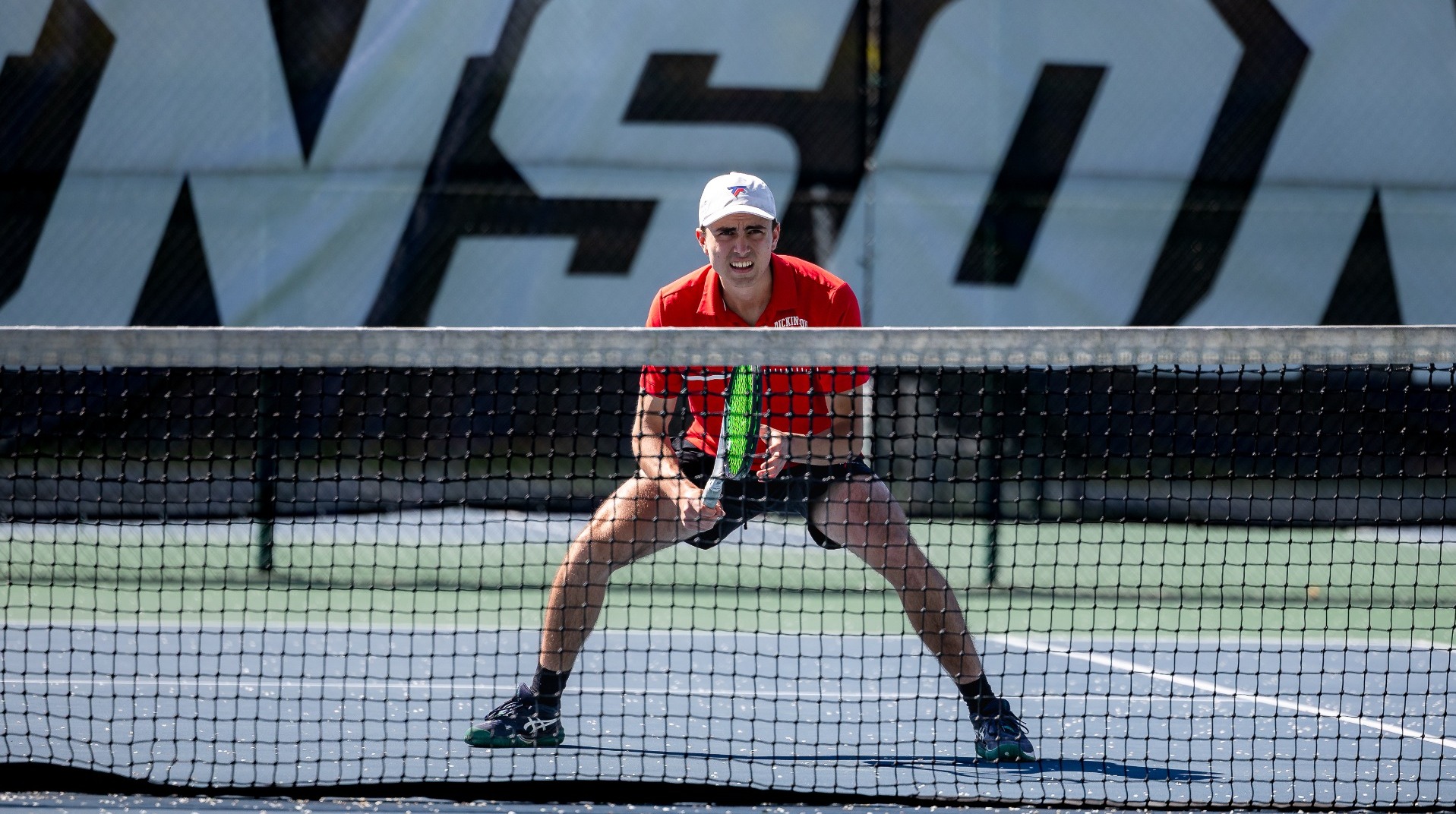Men's tennis player ready for net shot against McDaniel College on 4-11-26