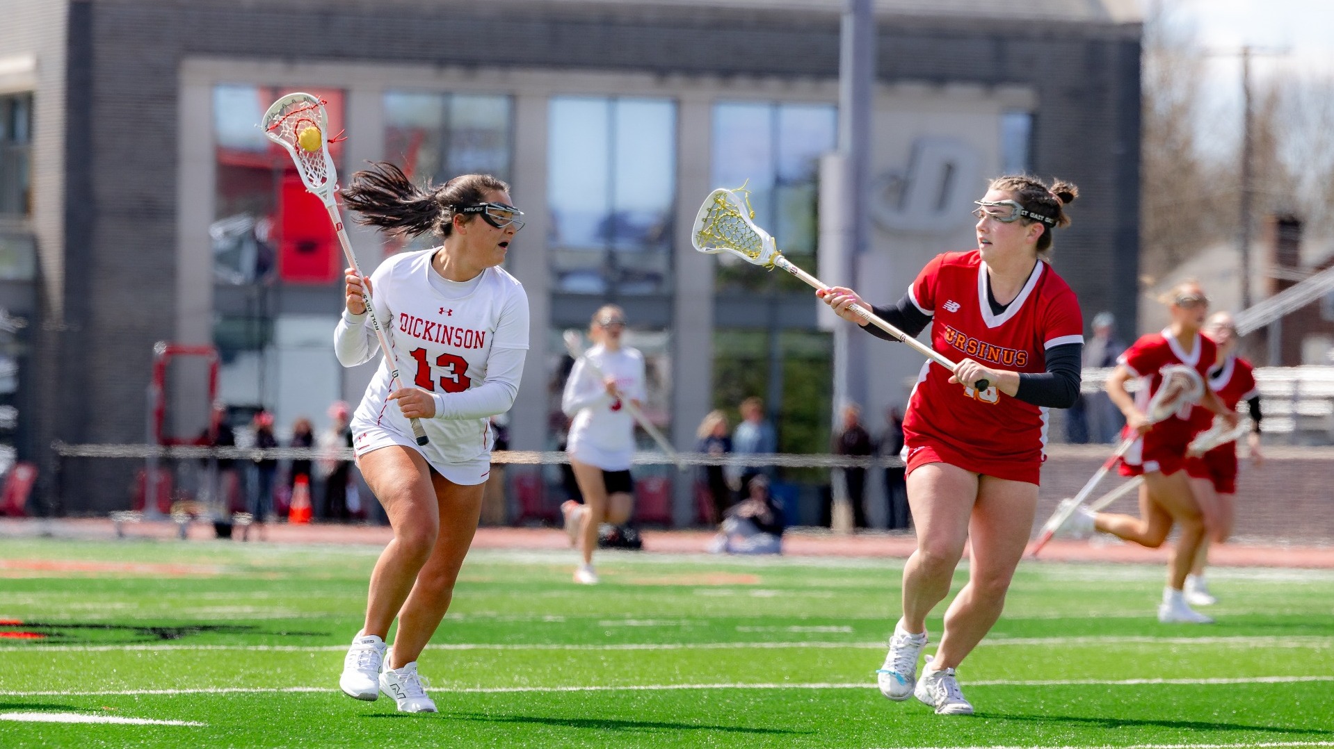 Abby Geary looking to make a pass against Ursinus College on 3-28-26