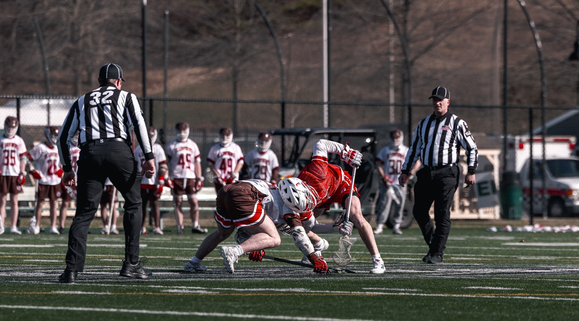 Ryan Backus going for a faceoff against St. Lawrence University on 3-13-26