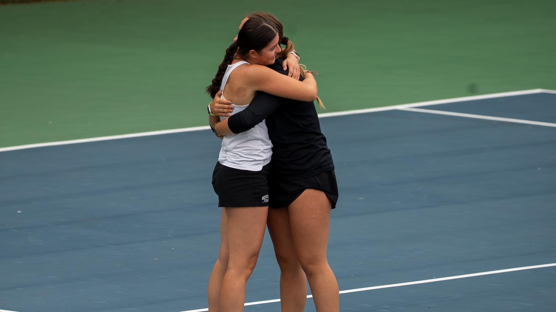 Anabel Romero Gemmell and Merve Uyumazturk hugging after winning at two doubles against Washington College on 4-28-26