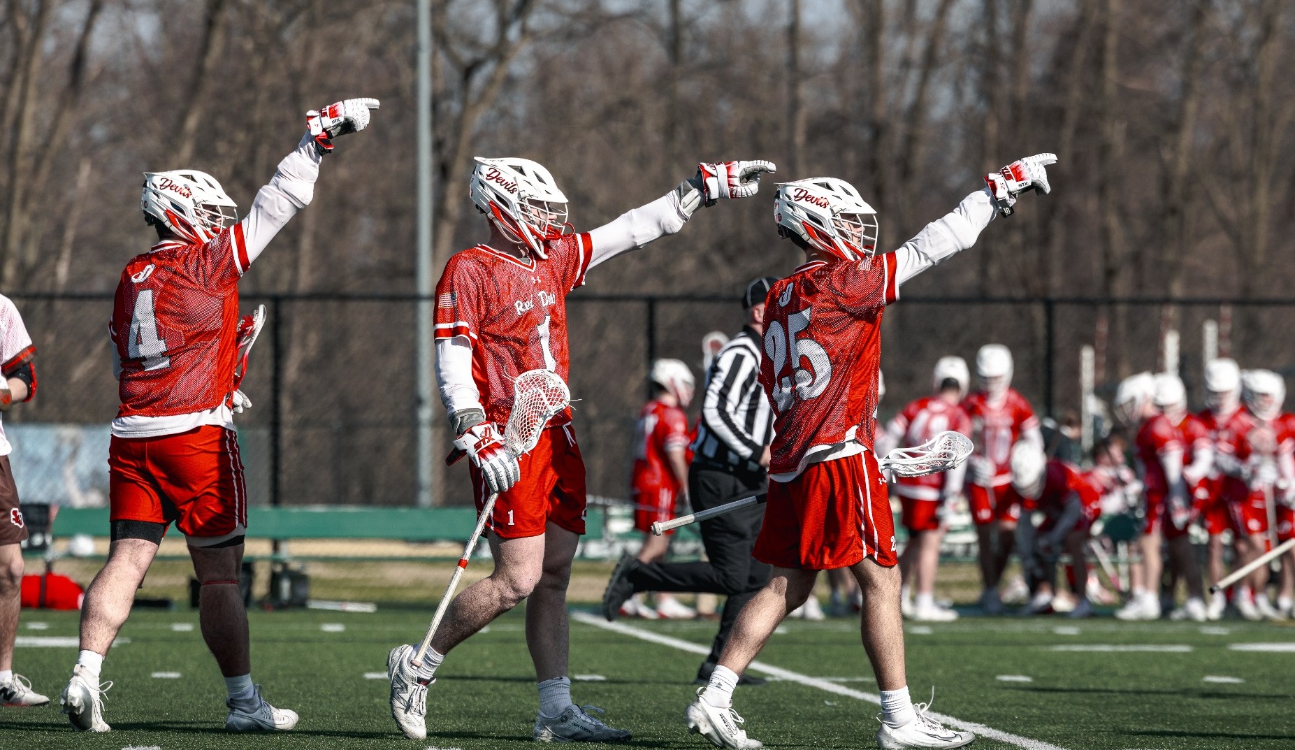 Landen Hyatt, Ramsey Huggins and Preston Boyd pointing out to midfield against St. Lawrence University on 3-13-26 at the Mustang Classic