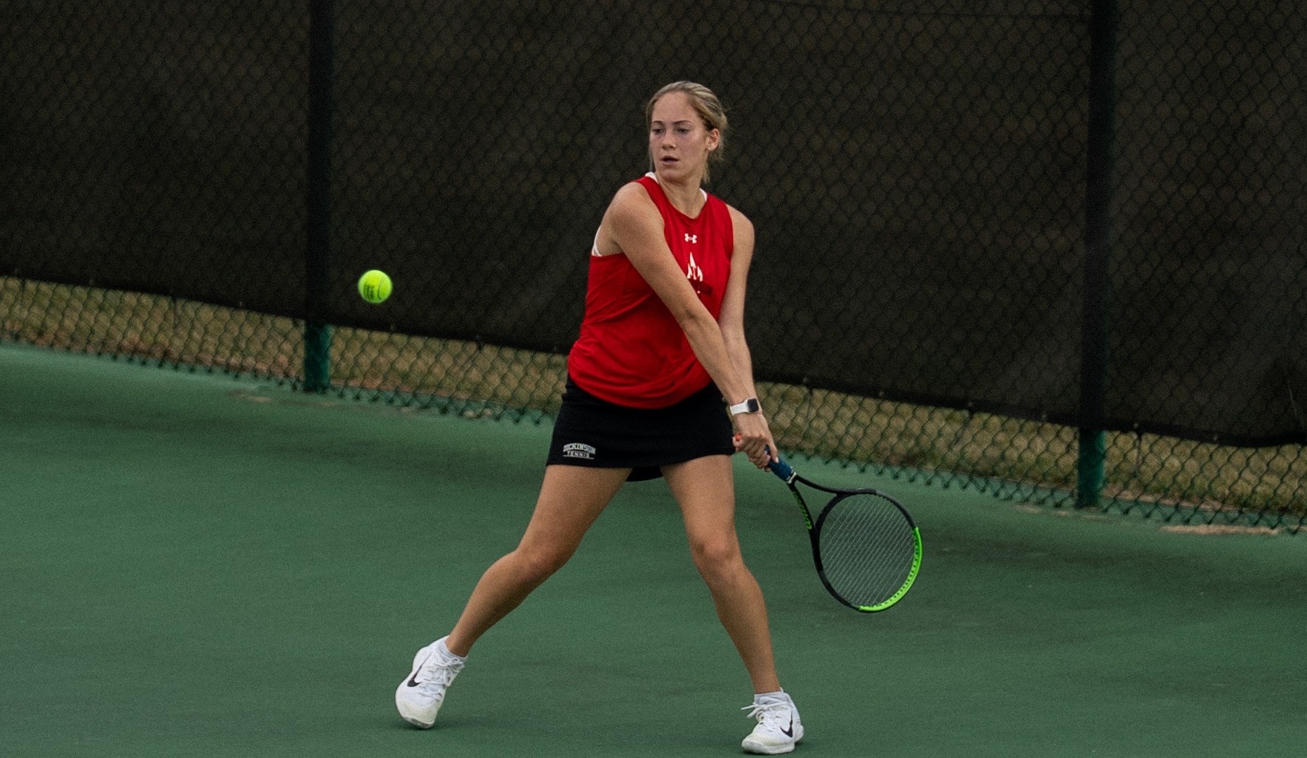 Women's tennis player attempting a backhand against Catholic University during the fall of 2025