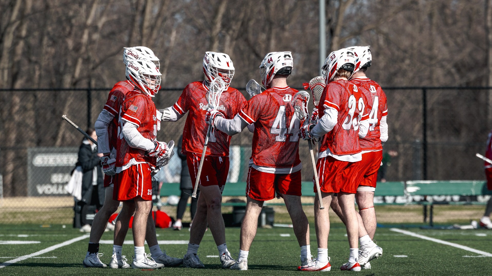 Group celebration after a goal against St. Lawrence University on 3-13-26