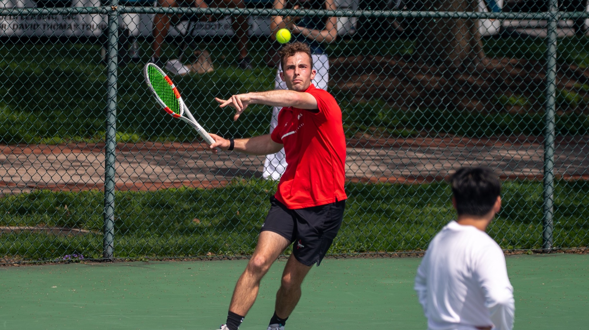 Men's tennis player going for a forehand against Ursinus College on 4-4-26