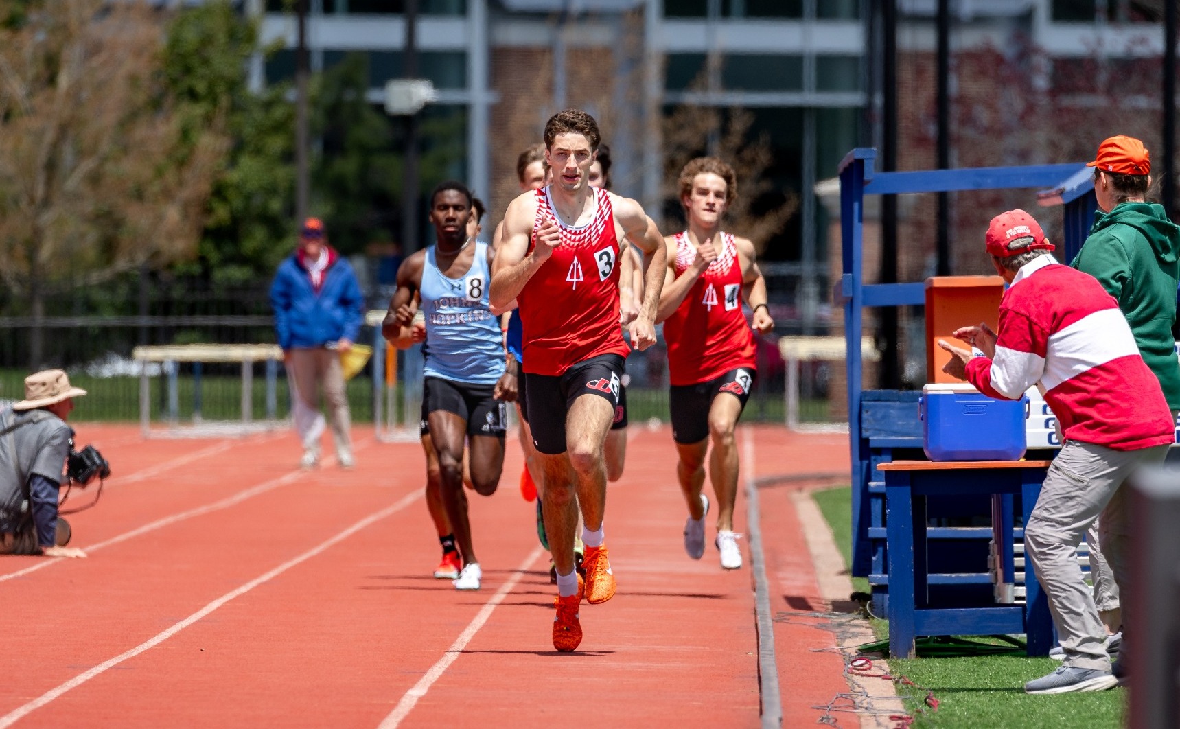 Trevor Richwine runs down the track, leading a pack of runners