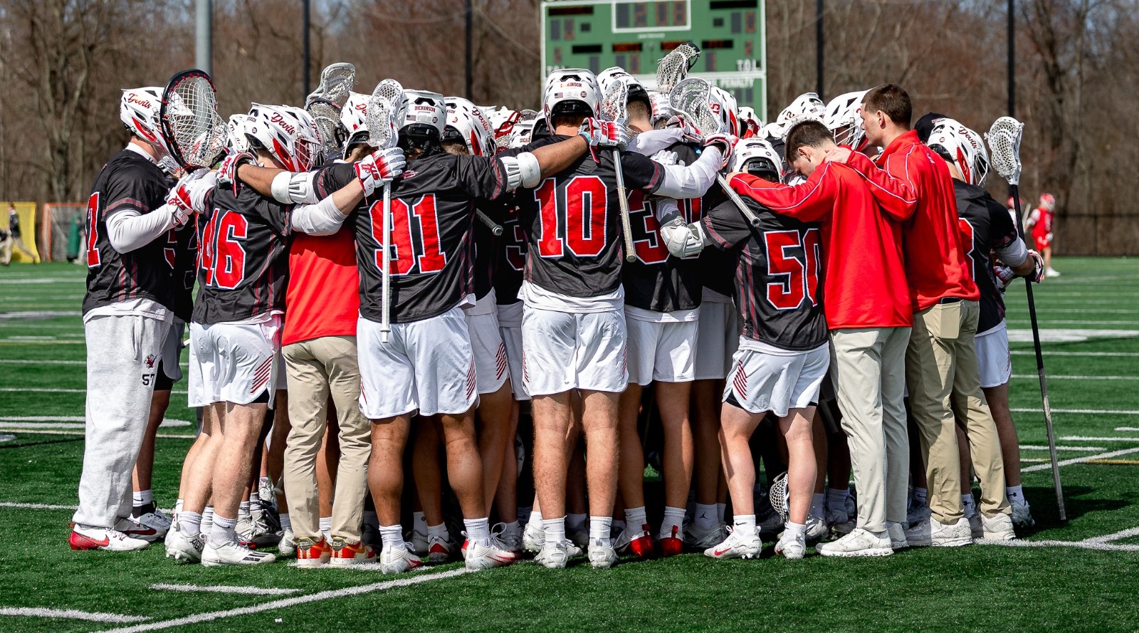 Men's lacrosse team huddle against Denison University on 3-13-26