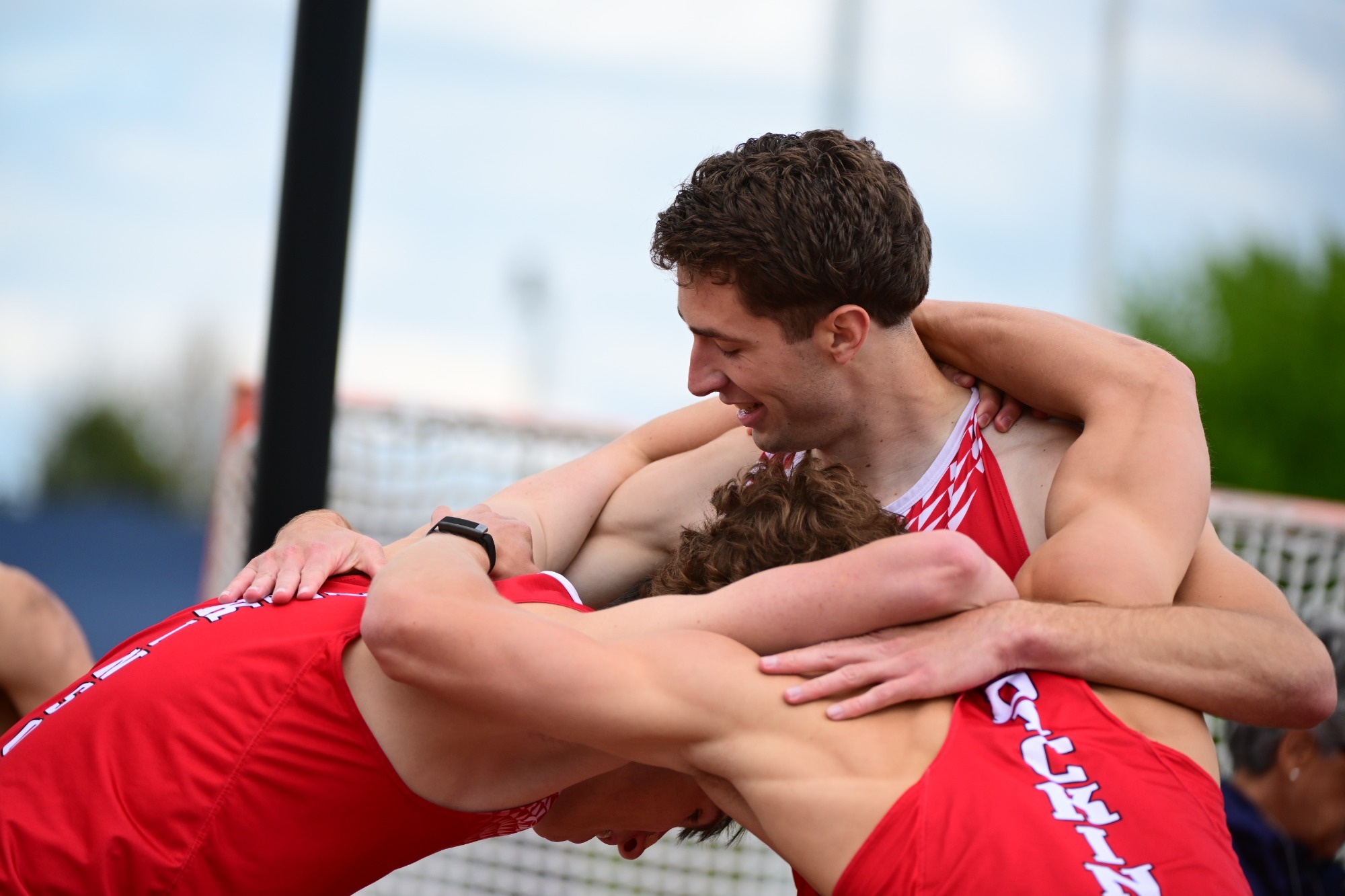 Trevor Richwine hugs and celebrates with teammates after a win